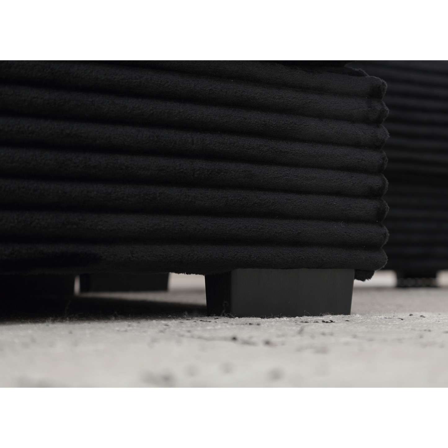 Black corduroy accent pillow with subtle ribbed texture