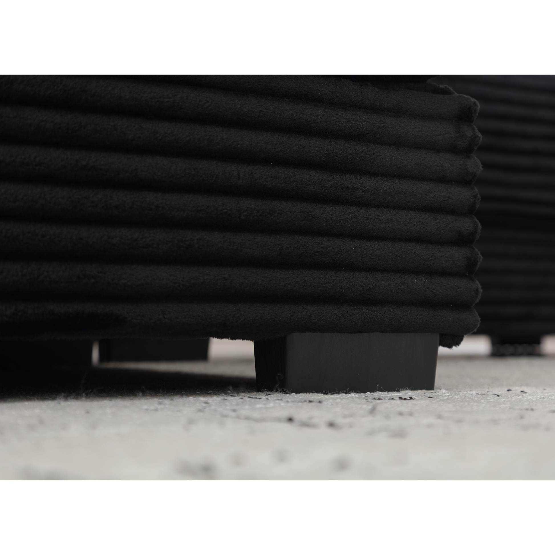 Black corduroy accent pillow with subtle ribbed texture