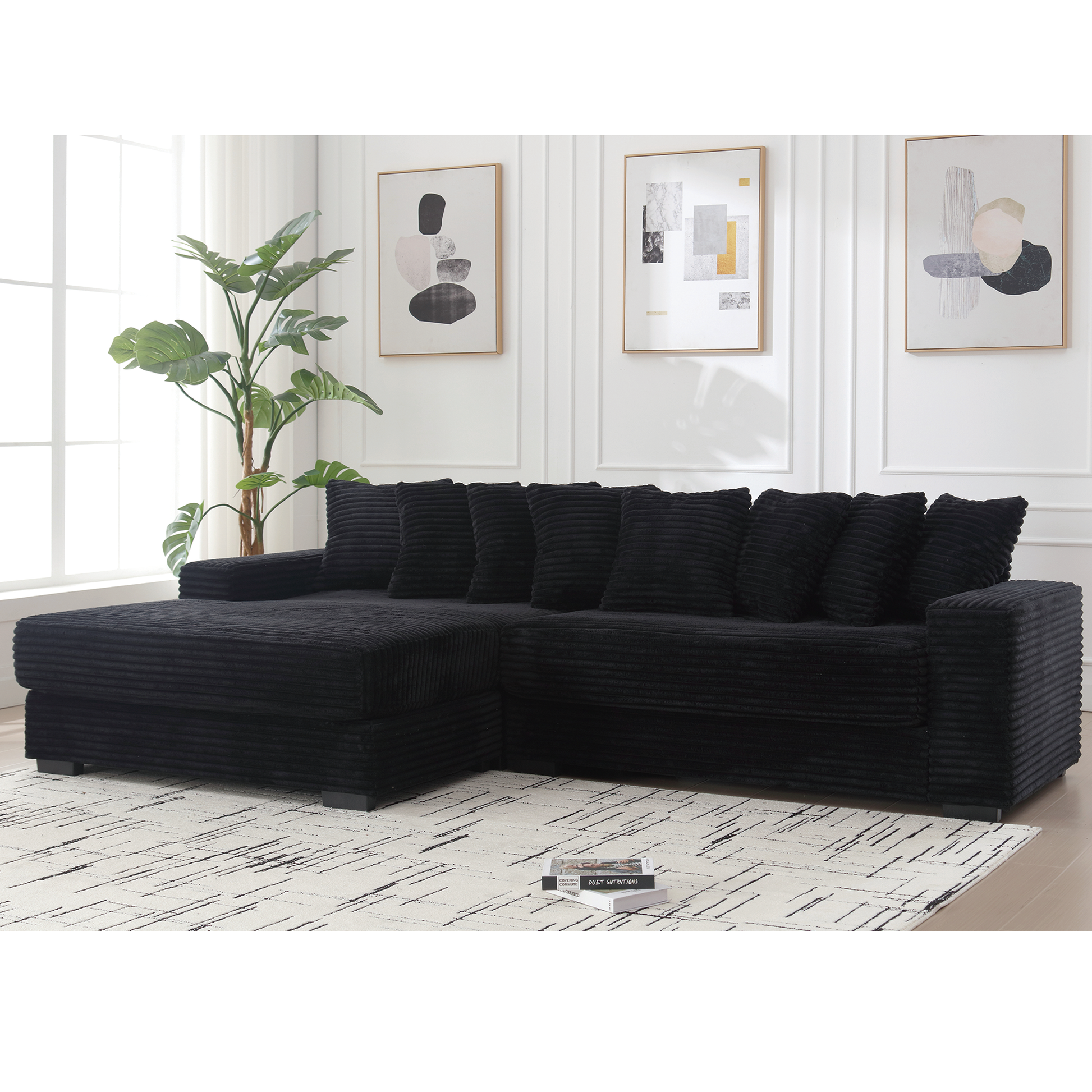 Black corduroy sectional sofa with plush cushions and chaise lounge