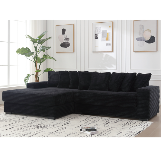 Black corduroy sectional sofa with plush cushions and chaise lounge