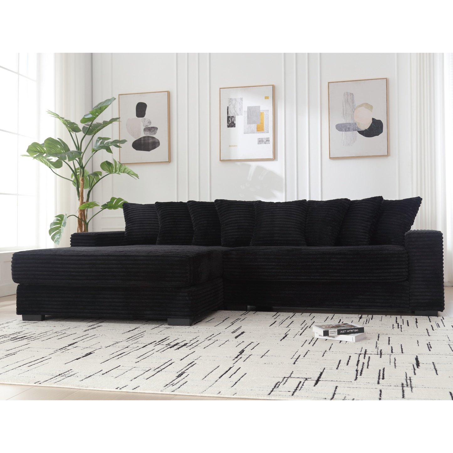 Black corduroy sectional sofa with plush pillows in a modern living room