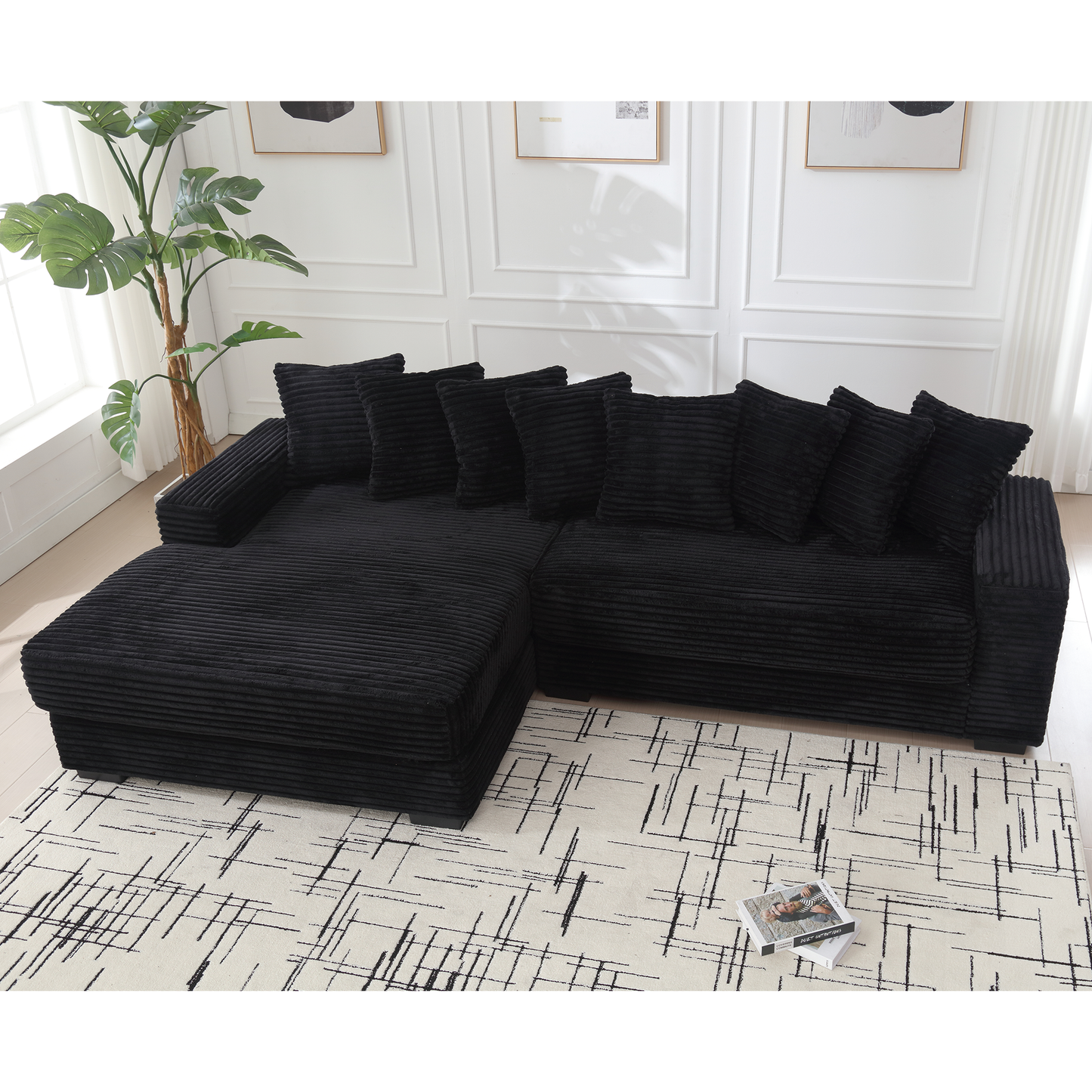 Plush black corduroy sectional sofa with matching throw pillows for a cozy living room