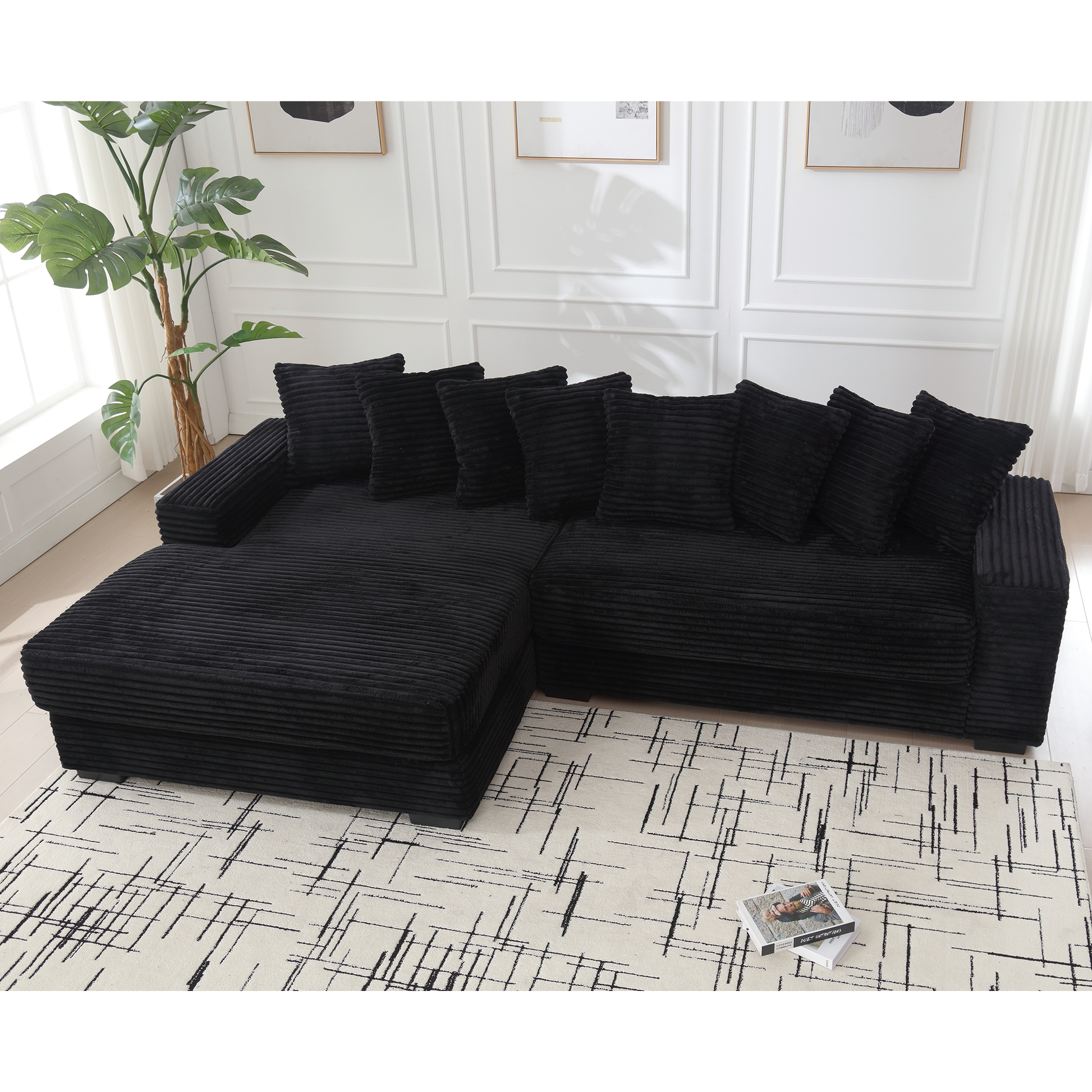 Plush black corduroy sectional sofa with matching throw pillows for a cozy living room