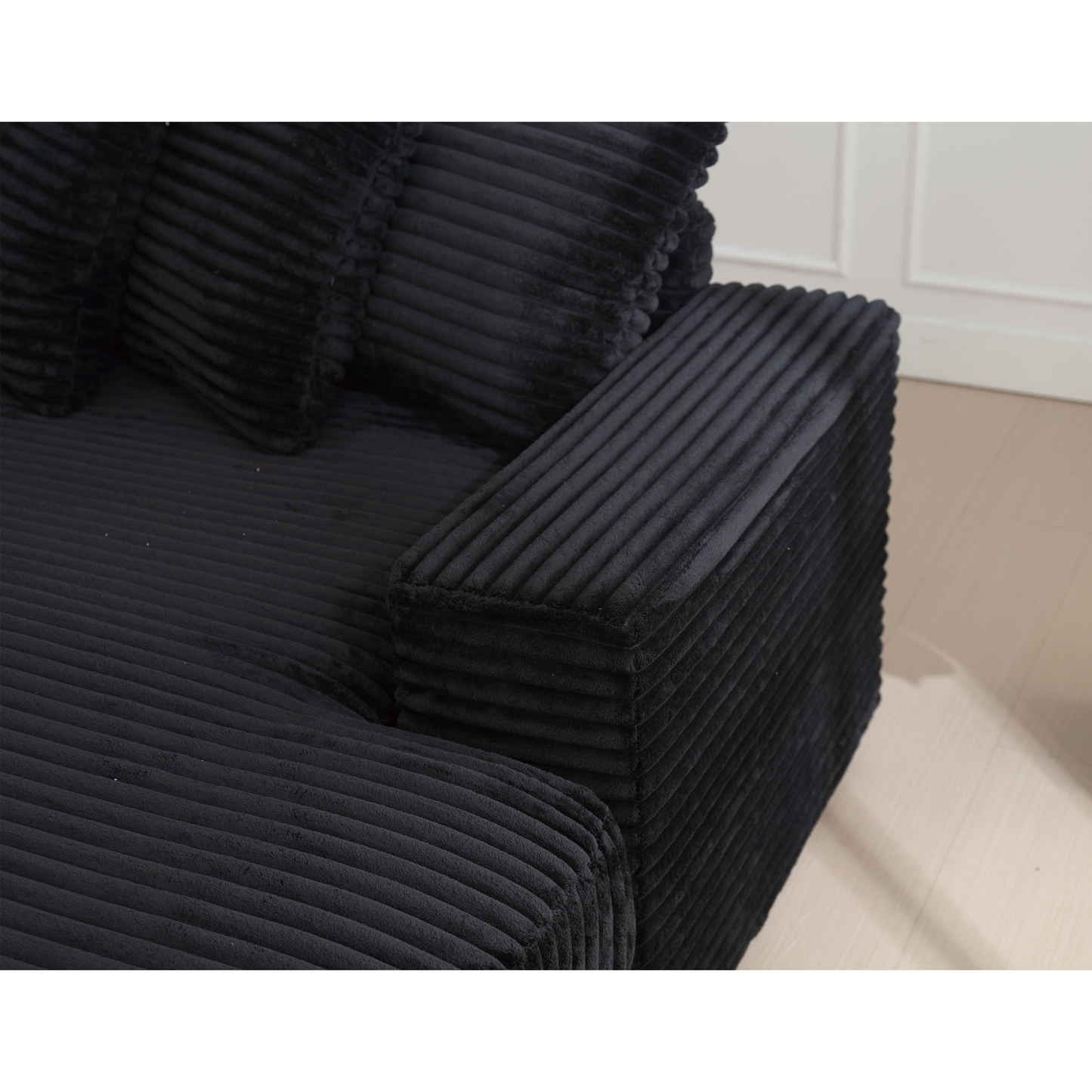 Black corduroy sofa armrest and seat cushions plush and textured