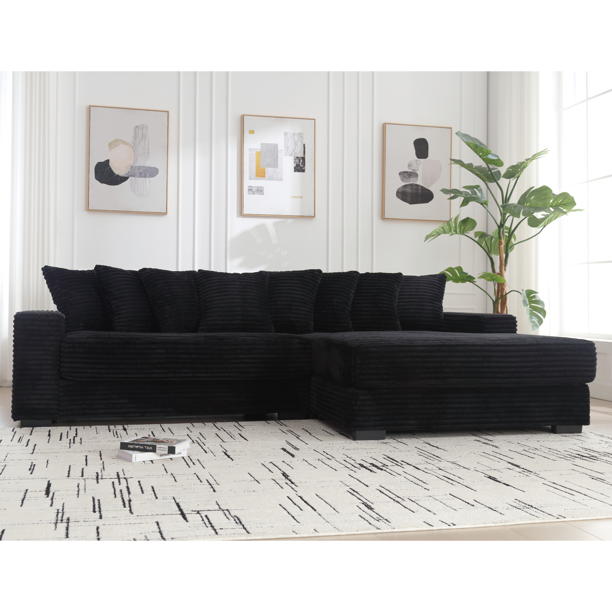Plush black corduroy sectional sofa with deep seats and throw pillows