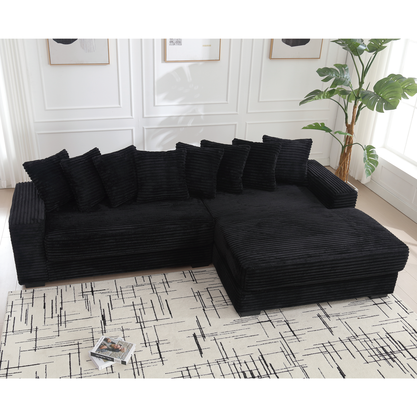Black corduroy sectional sofa with plush throw pillows perfect for a modern living room