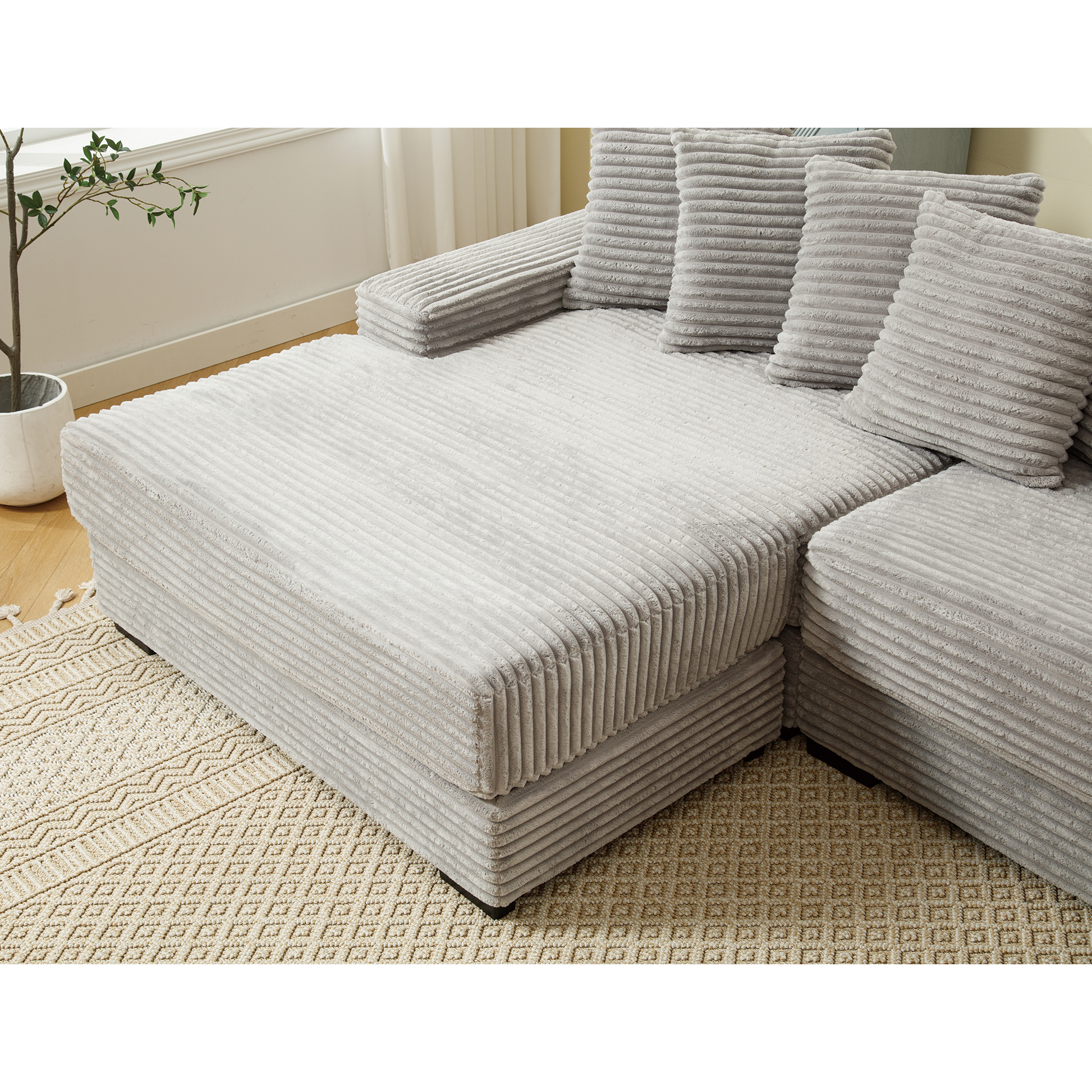 Comfortable light gray corduroy sectional sofa with plush cushions for a cozy living room