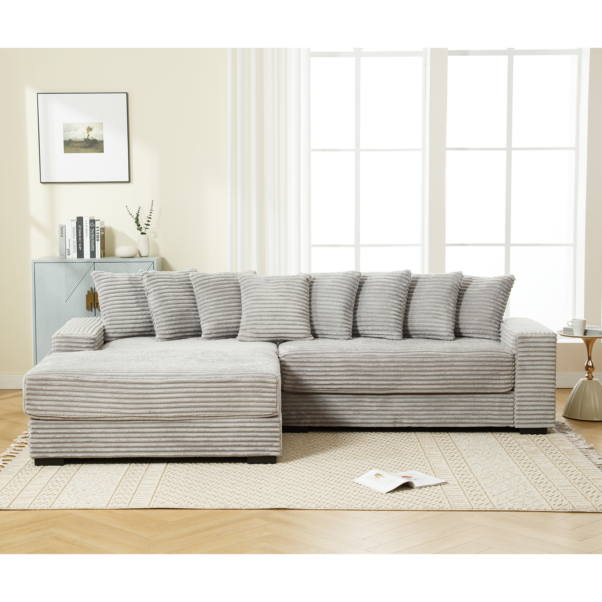 Light gray corduroy sectional sofa with plush pillows in a living room setting