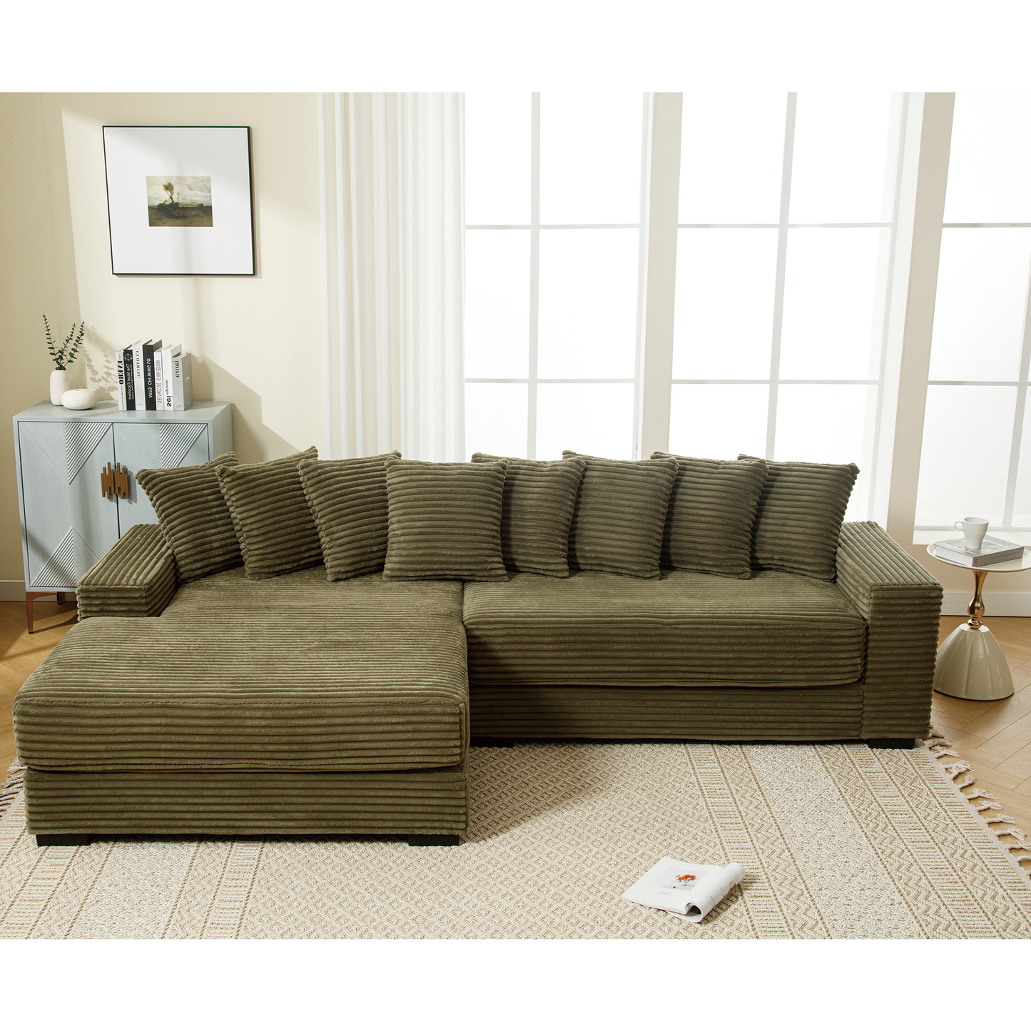 Olive green corduroy sectional sofa with plush throw pillows and chaise lounge