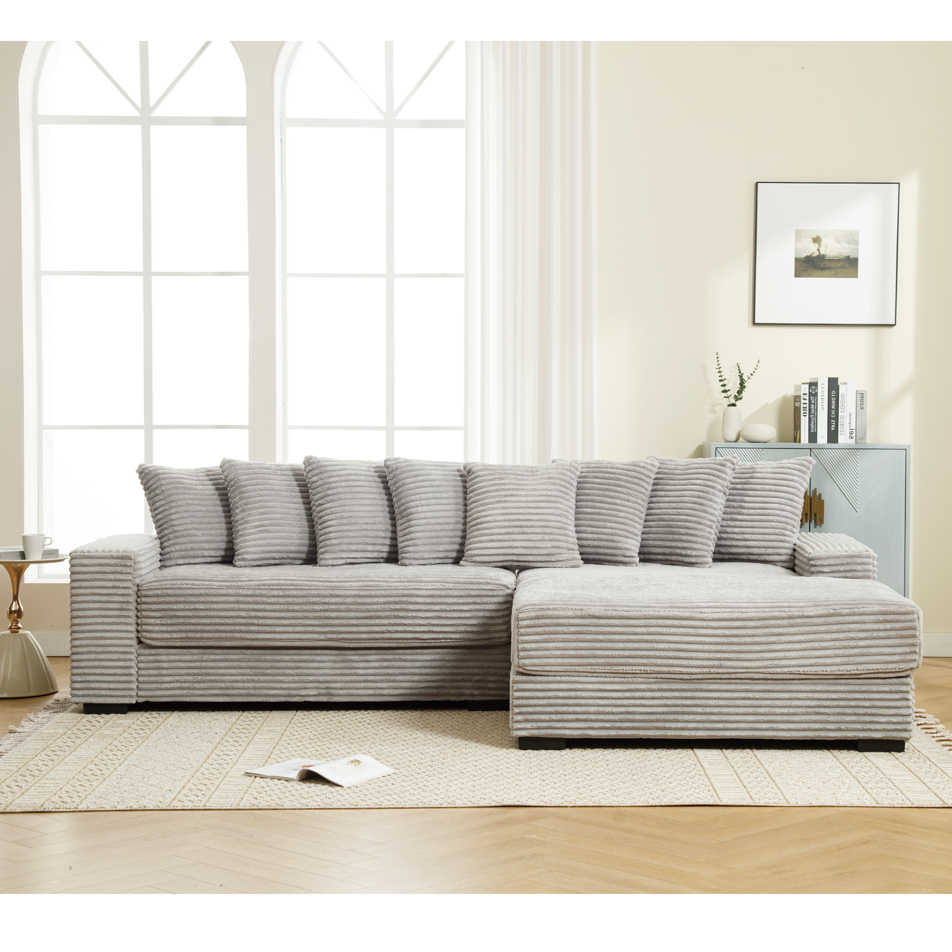 Plush corduroy sectional sofa in light grey with wide ribbed texture and plush throw pillows