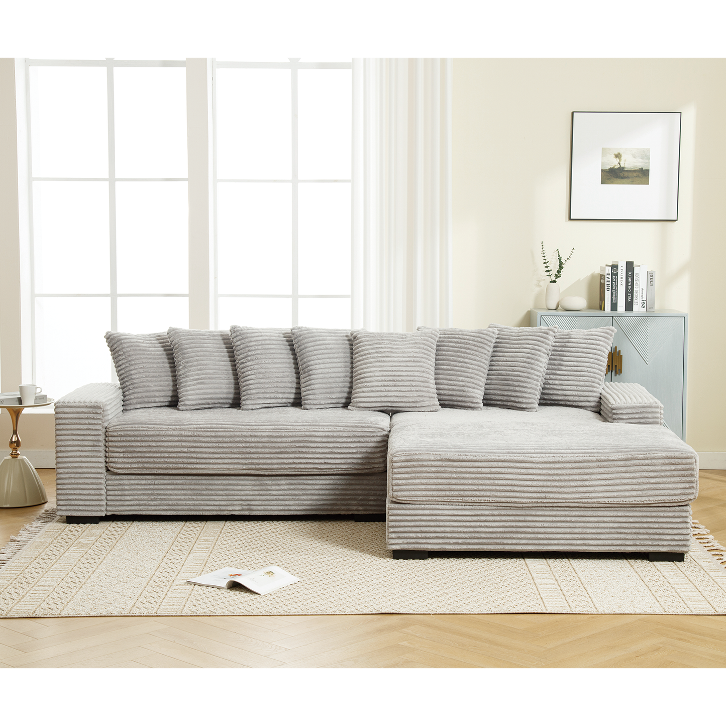 Light gray corduroy sectional sofa with plush pillows and chaise lounge