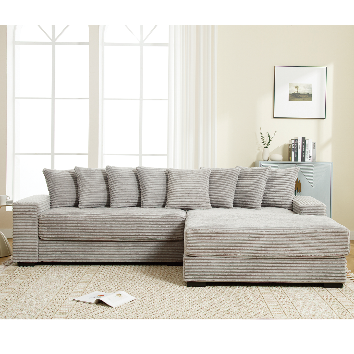 Comfortable light grey corduroy sectional sofa with plush throw pillows