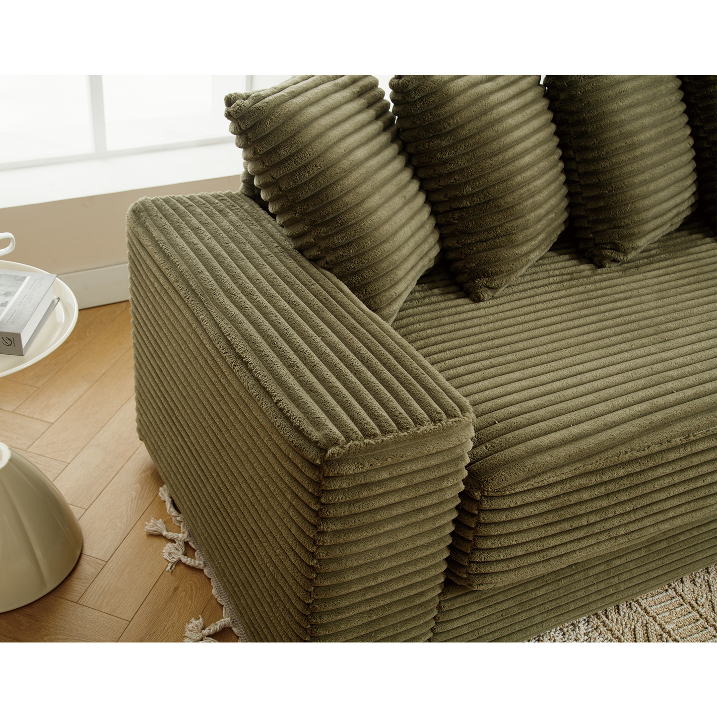 Sage green corduroy sectional sofa with plush throw pillows
