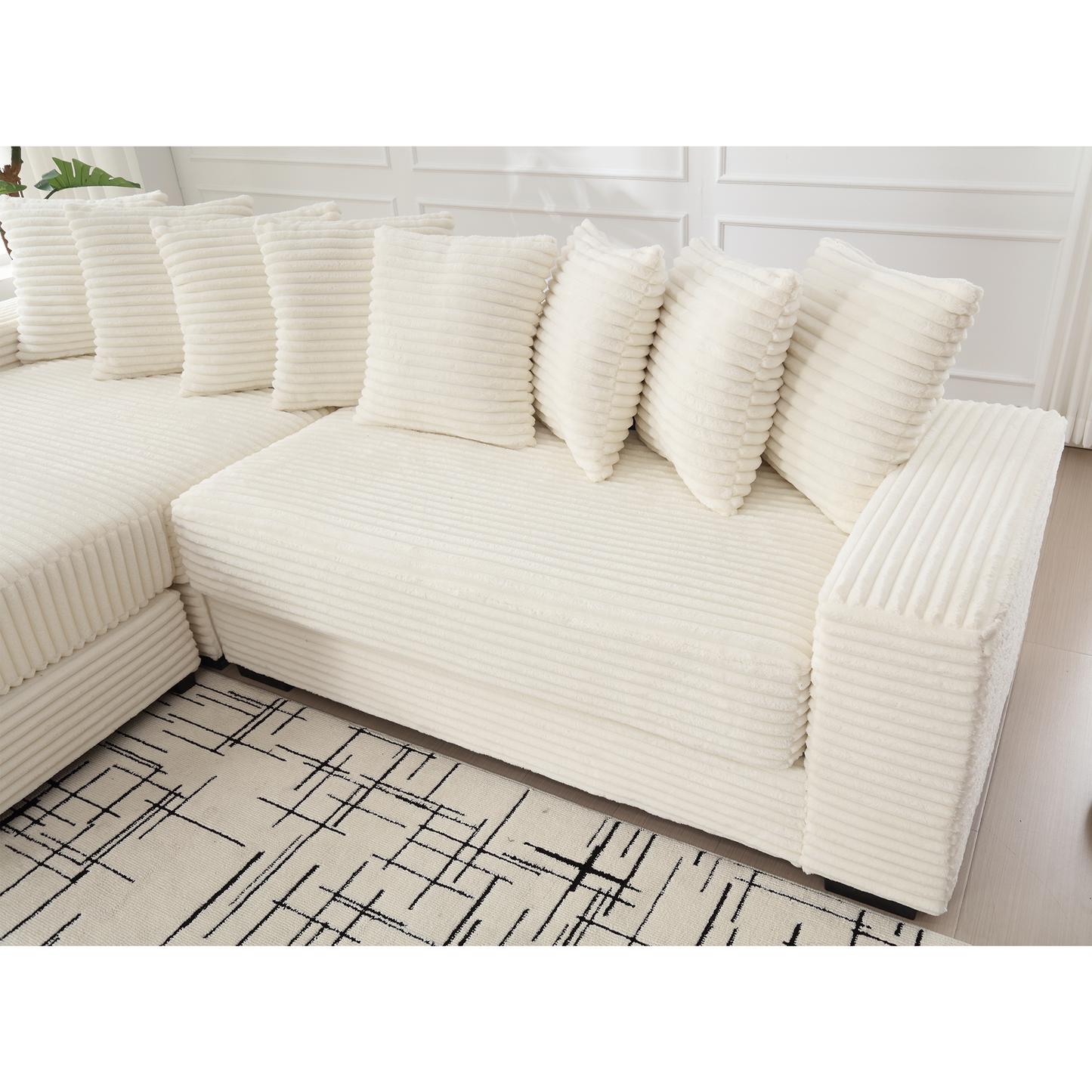 Cream corduroy sectional sofa with plush throw pillows for a cozy living room