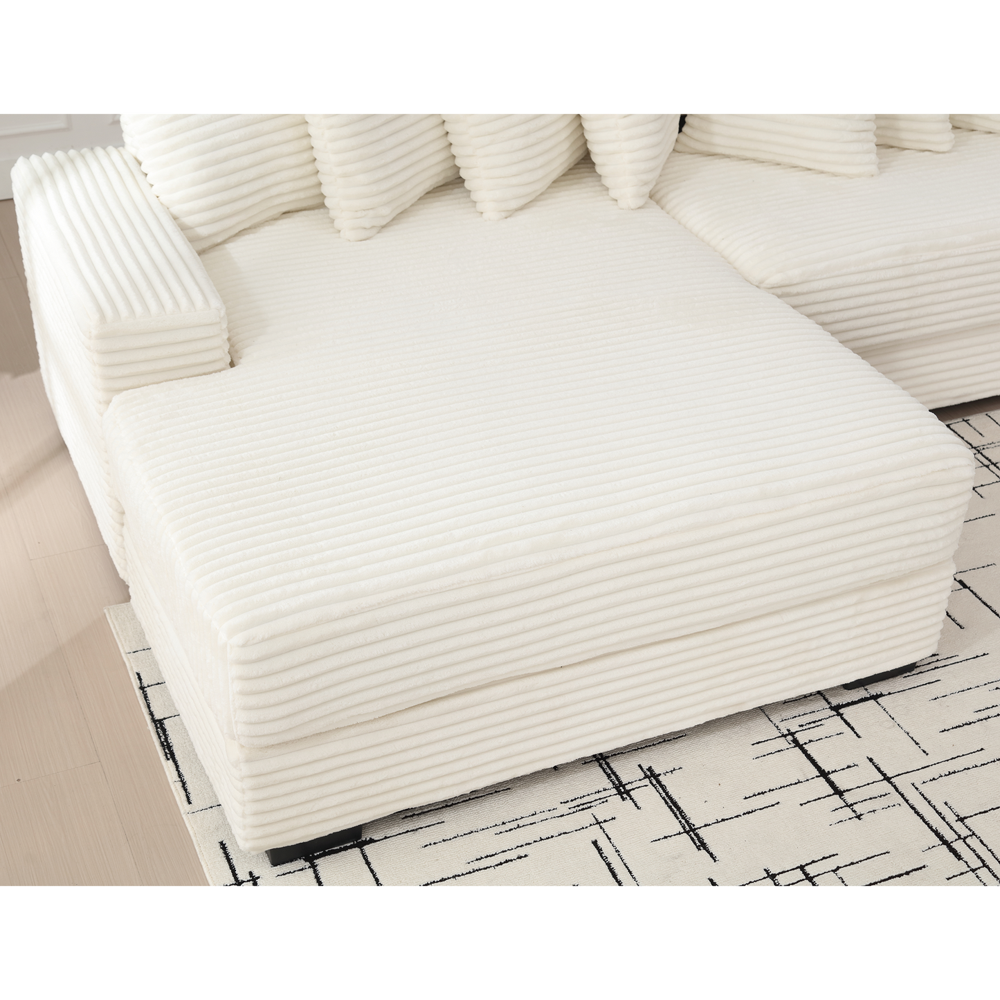 Plush ivory corduroy sectional sofa with plush armrest and inviting chaise lounge