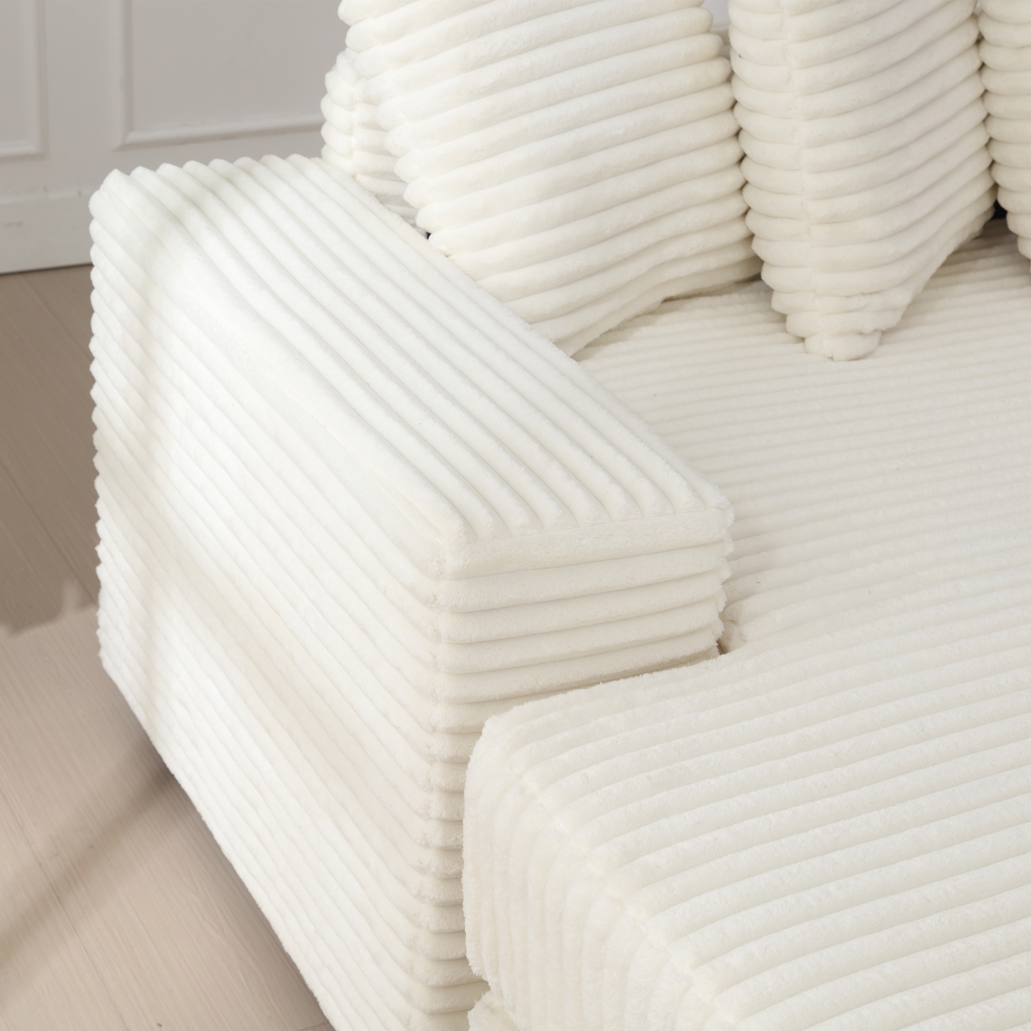 Textured ivory corduroy armchair with plush cushioning for comfort and style