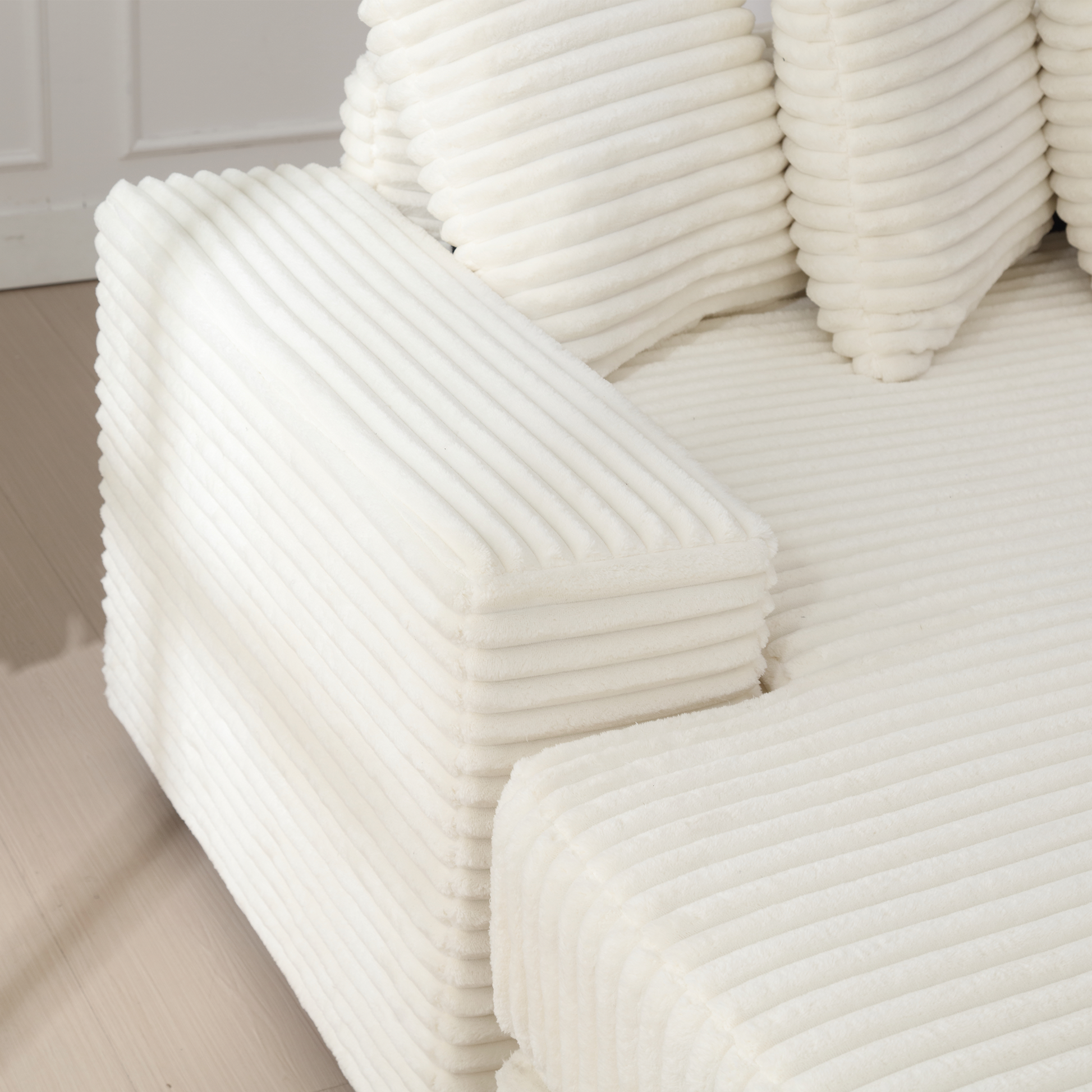 Textured ivory corduroy armchair with plush cushioning for comfort and style