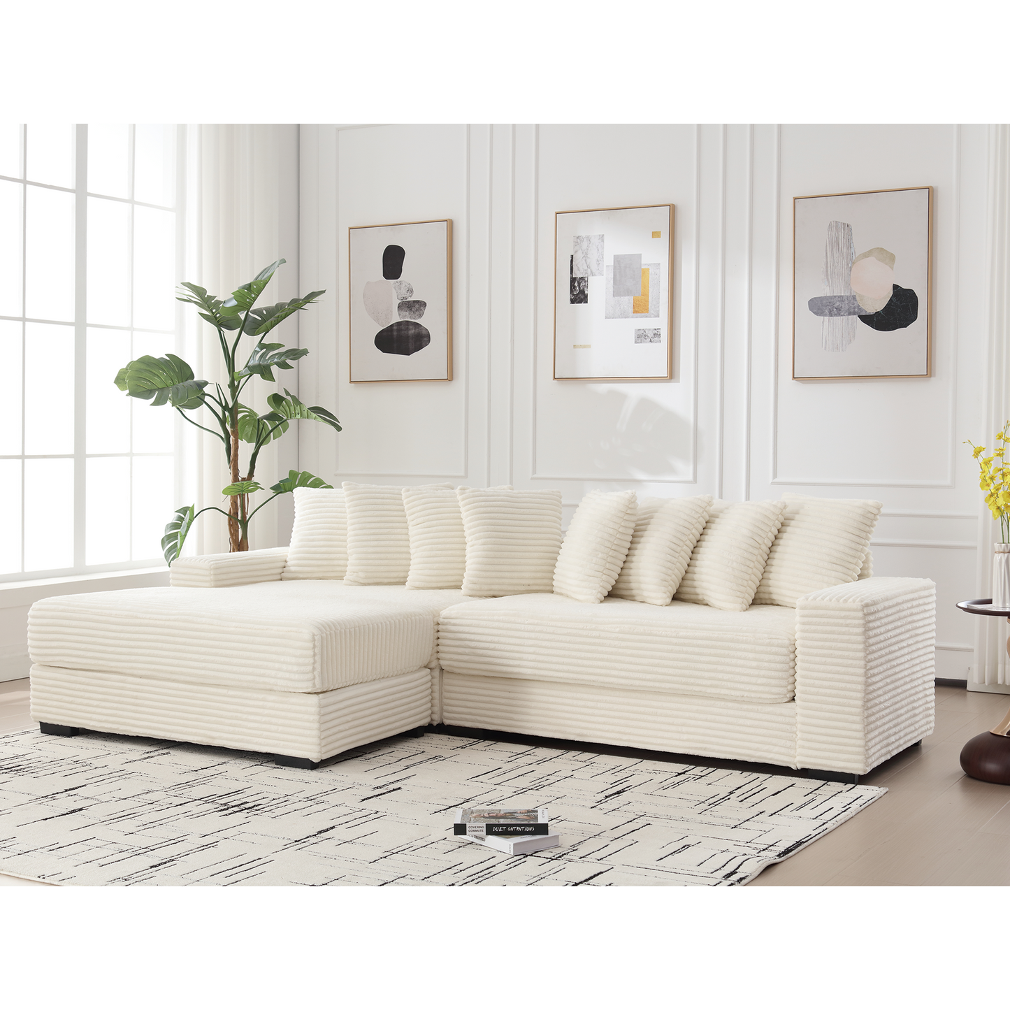 Plush cream corduroy sectional sofa with matching throw pillows on a modern rug