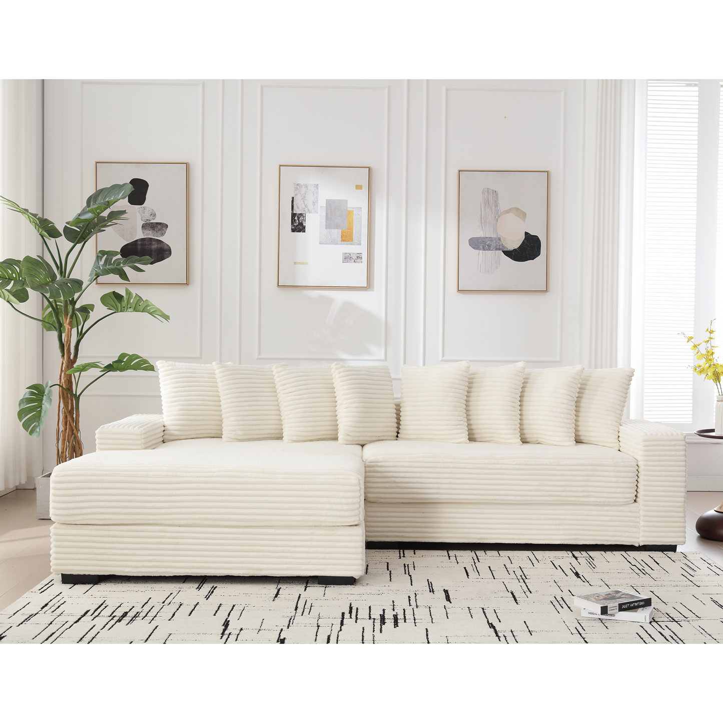 Cream corduroy sectional sofa with plush cushions and modern abstract art