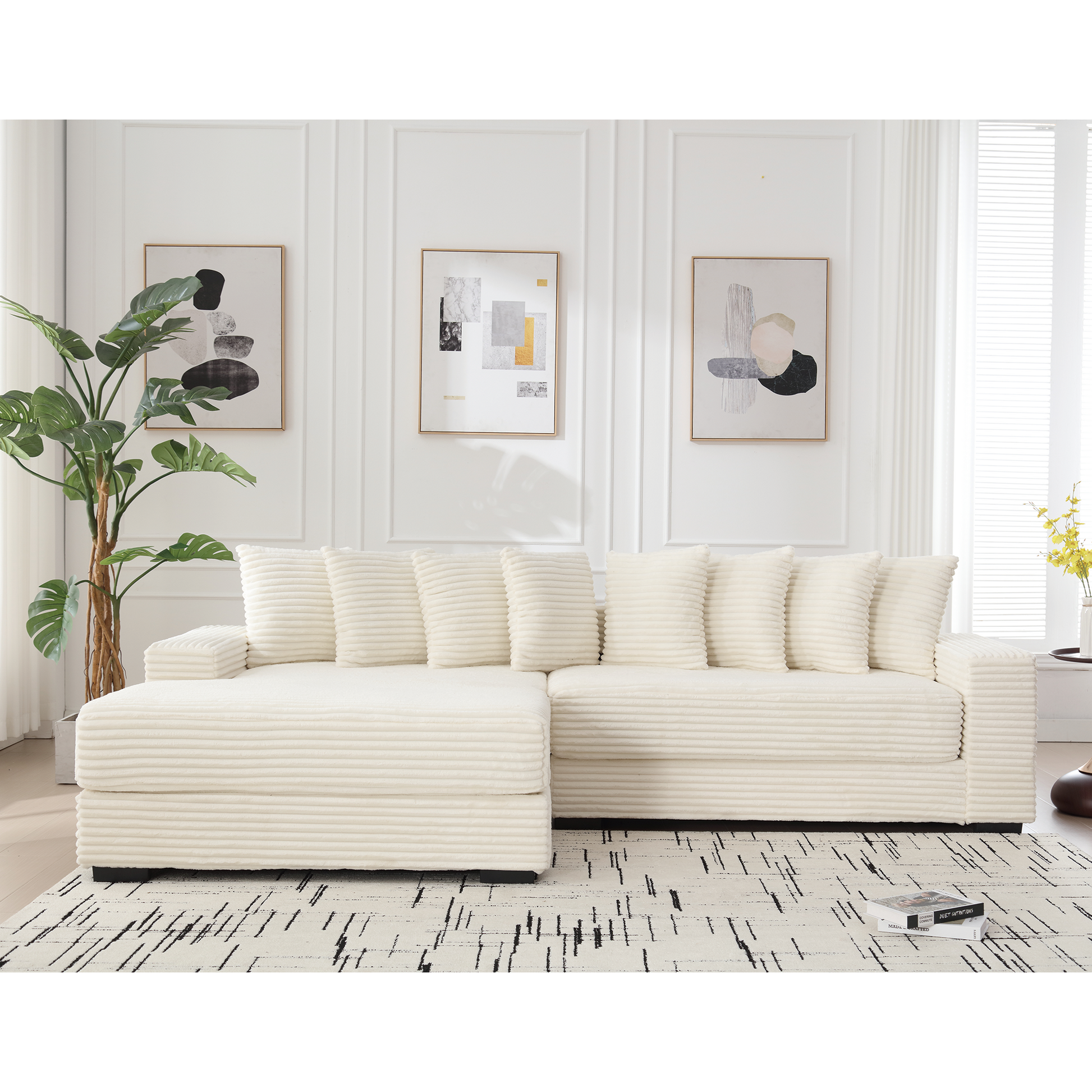 Cream corduroy sectional sofa with plush cushions and modern abstract art