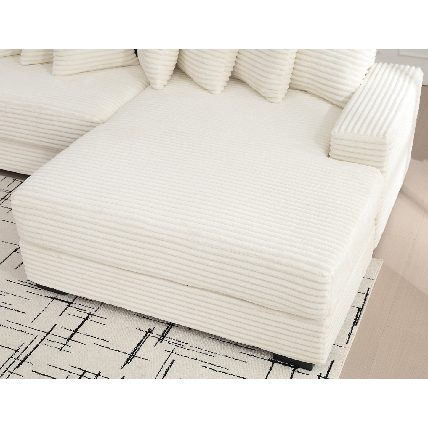 Cream corduroy sectional sofa with plush cushions and a chaise lounge