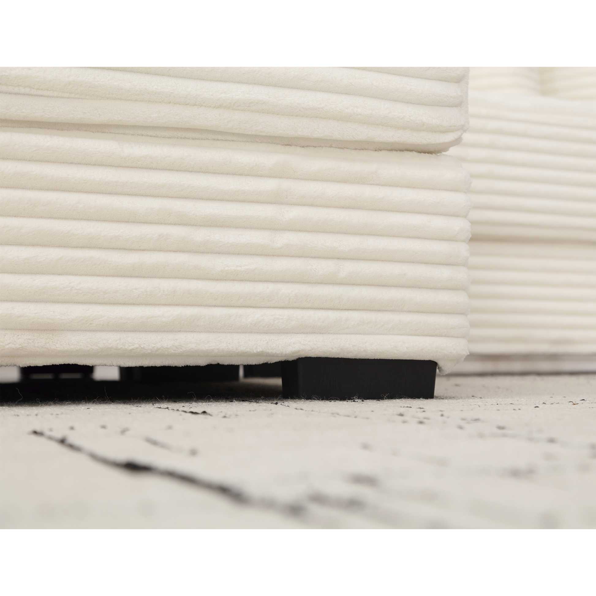 Cream corduroy sofa detail with black legs clean modern design
