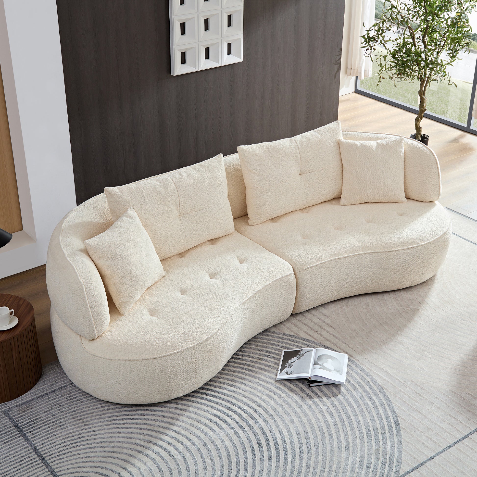 Curved cream boucle sectional sofa with plush throw pillows perfect for modern living rooms