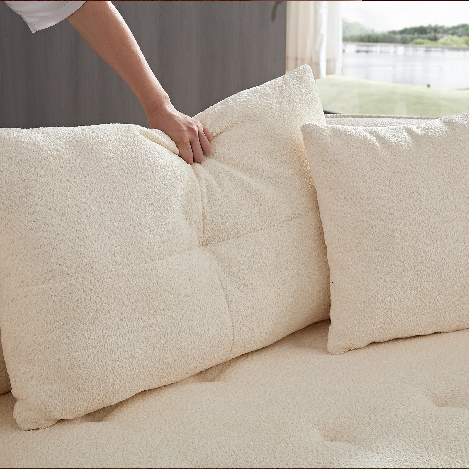Cream teddy fleece accent pillow with textured fabric and a quilted center for a cozy sofa