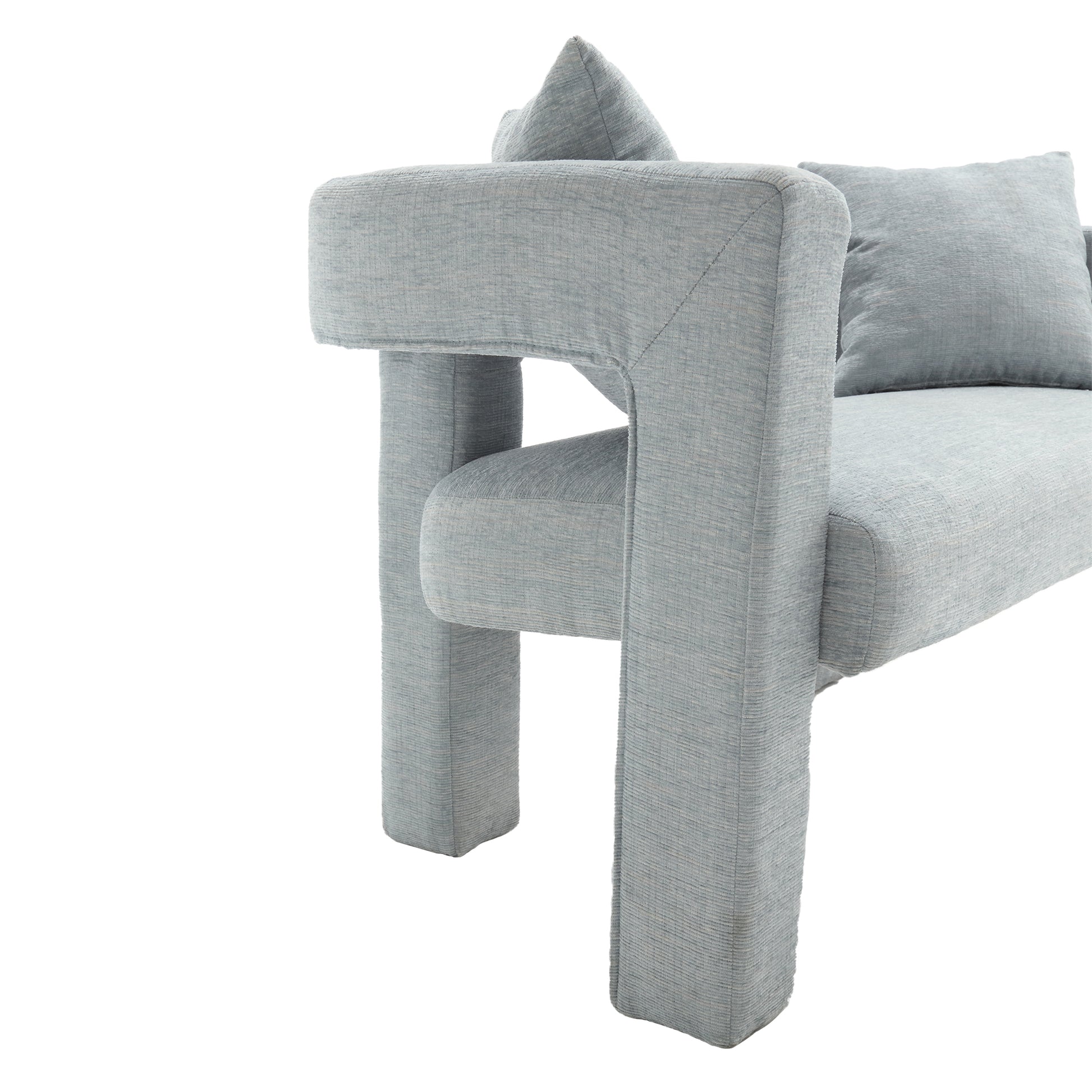 Soft blue fabric sofa with modern block arms and accent pillows