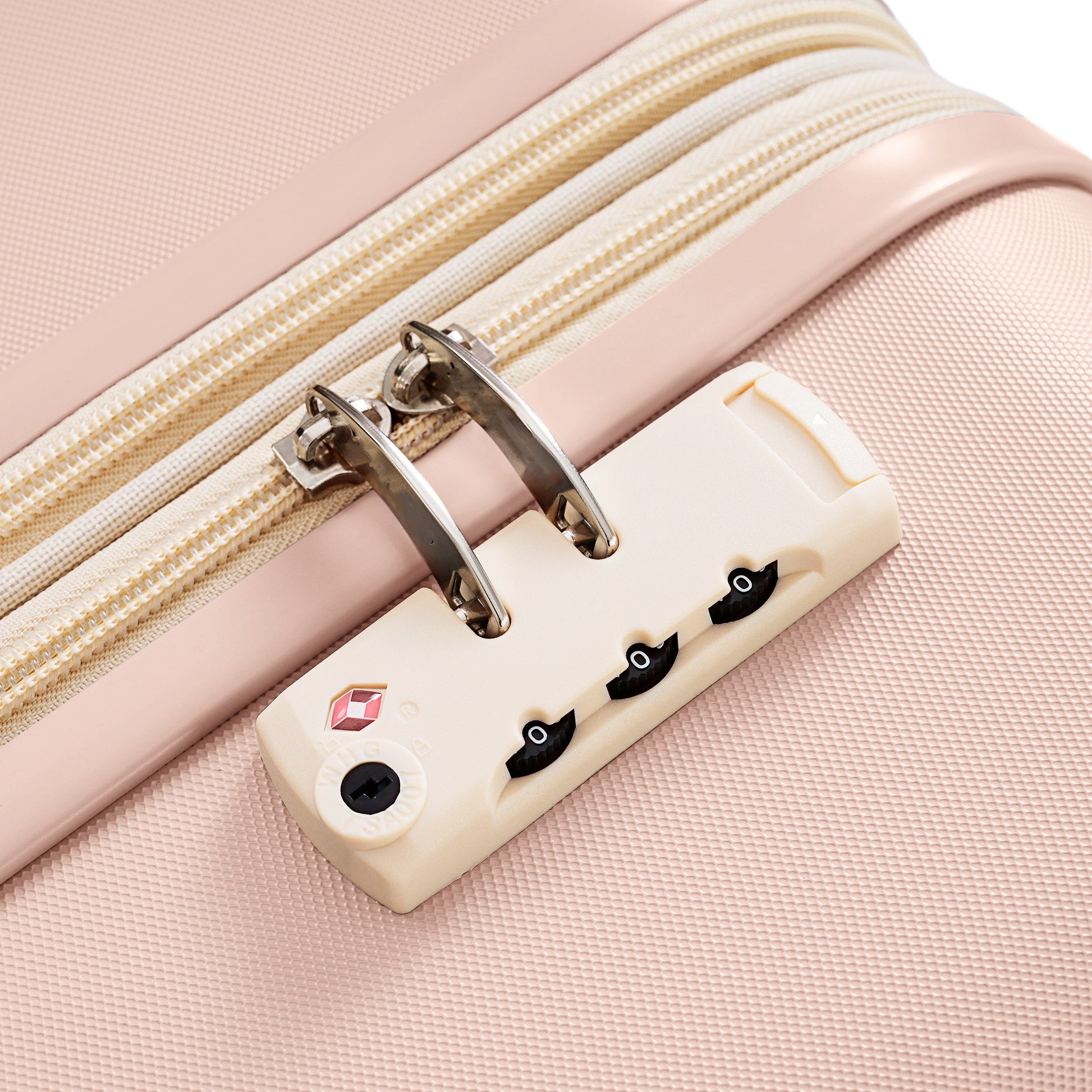 Closeup of a rose gold suitcase zipper with integrated TSA lock