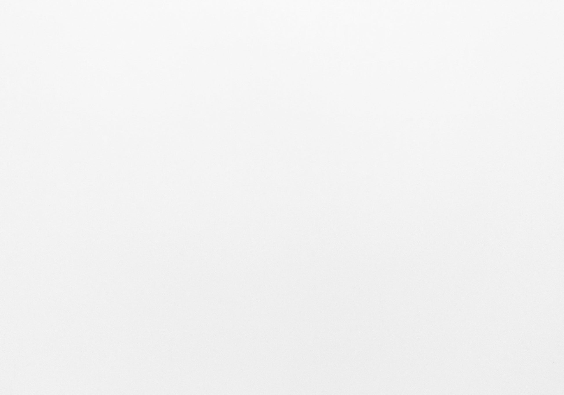 Textured white paper background ideal for minimalist stationery and invitations