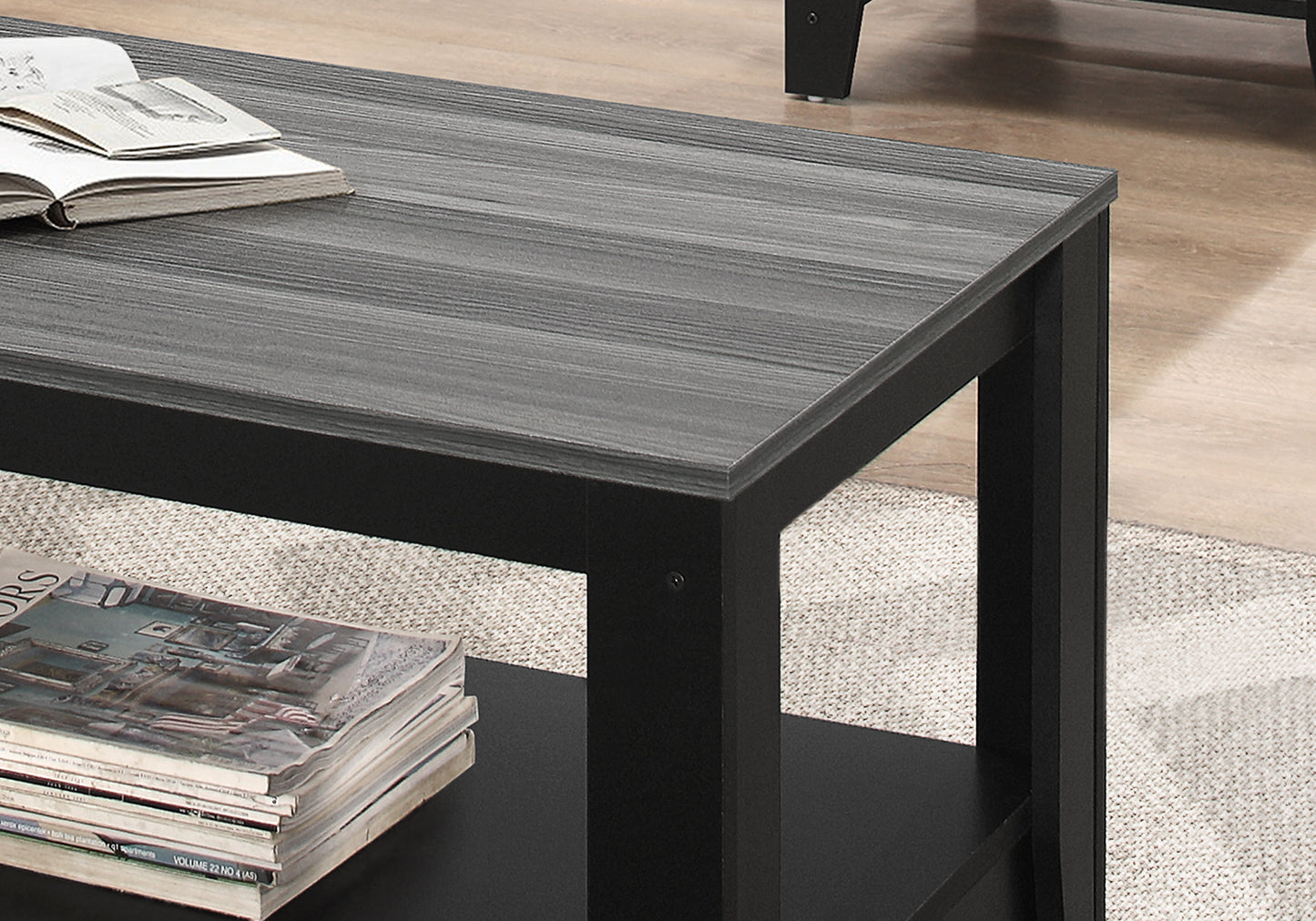 Modern grey wood grain coffee table with black frame featuring an open shelf
