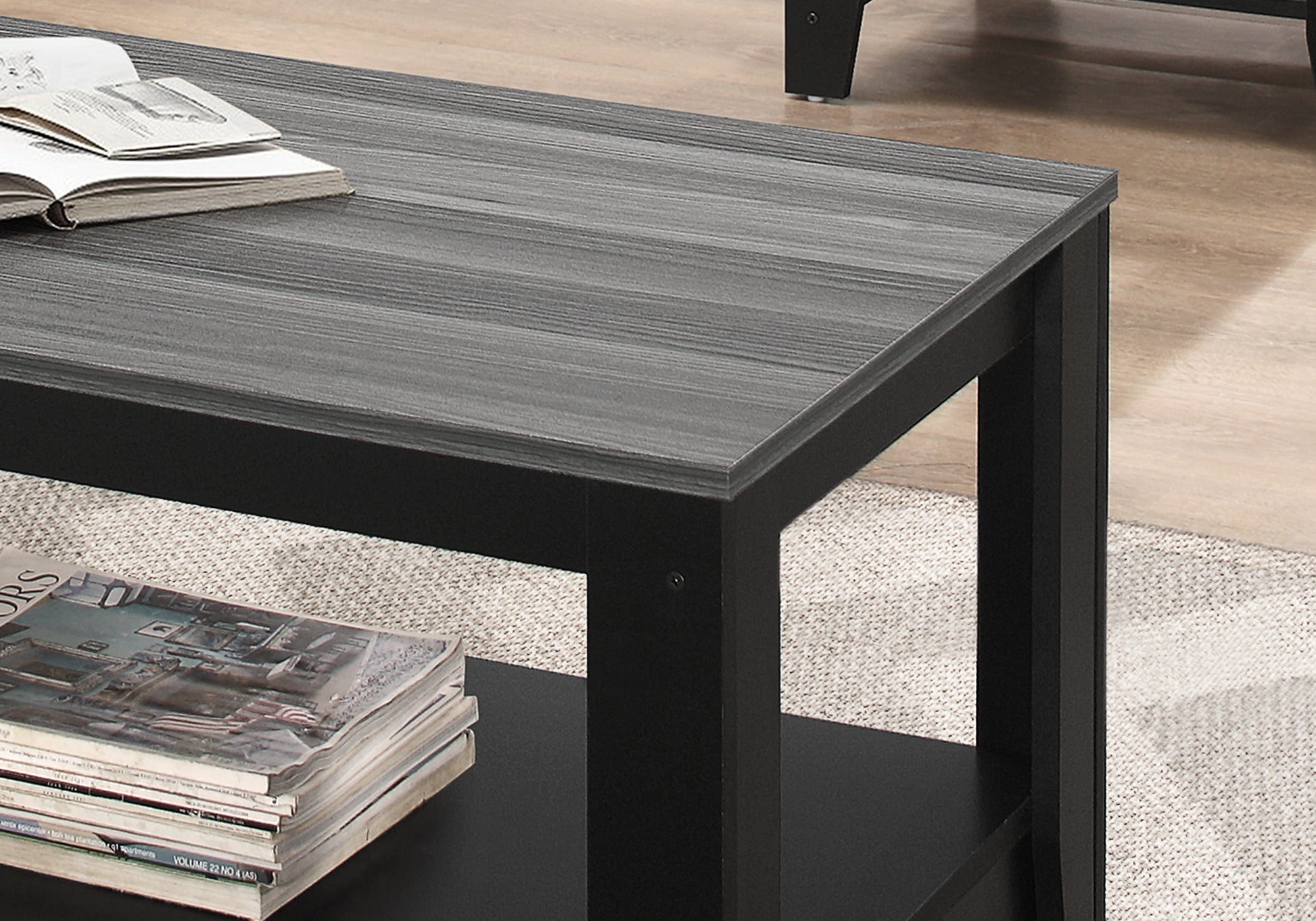 Modern grey wood grain coffee table with black frame featuring an open shelf