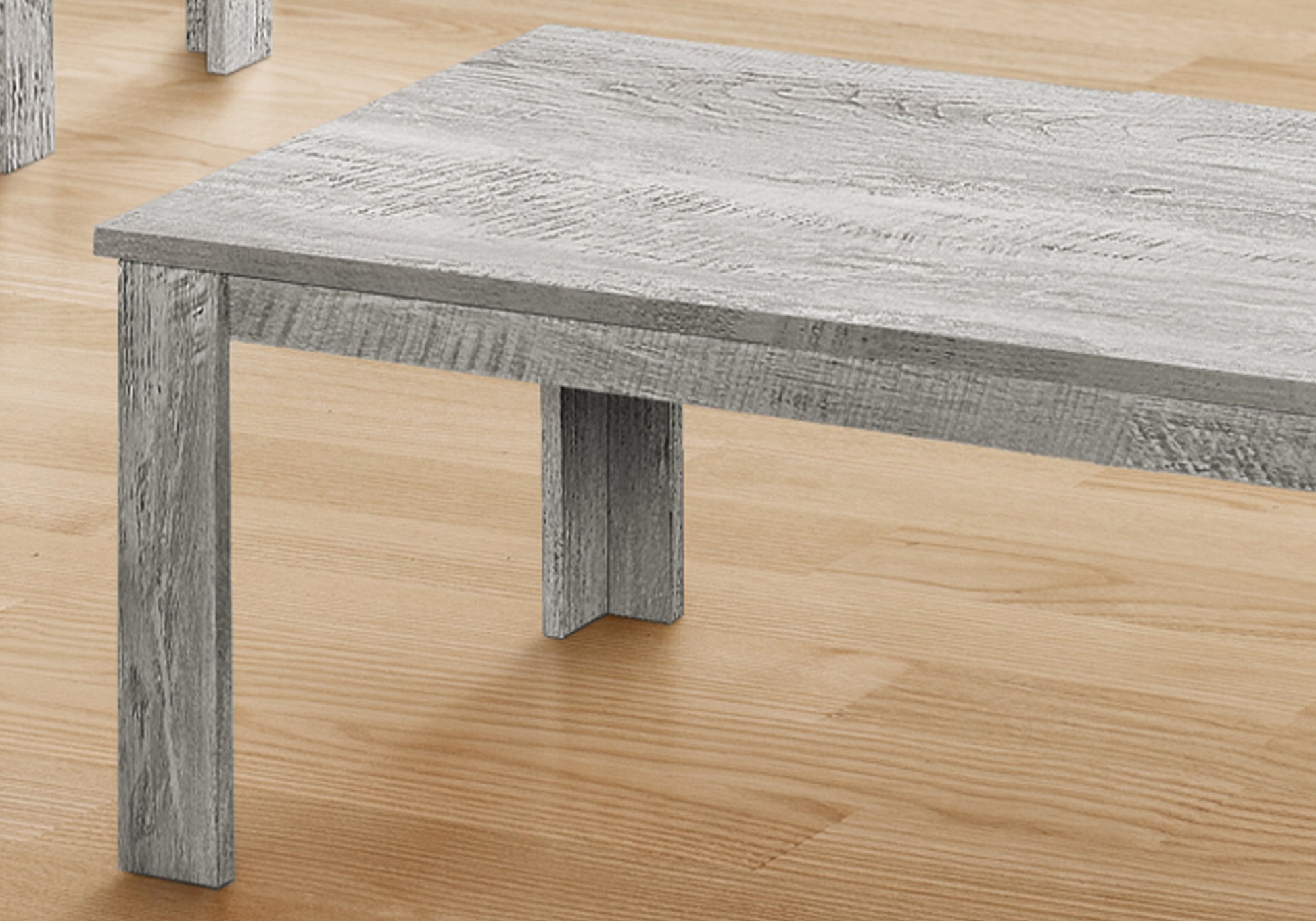 Rustic grey wood coffee table with textured finish perfect for modern living rooms