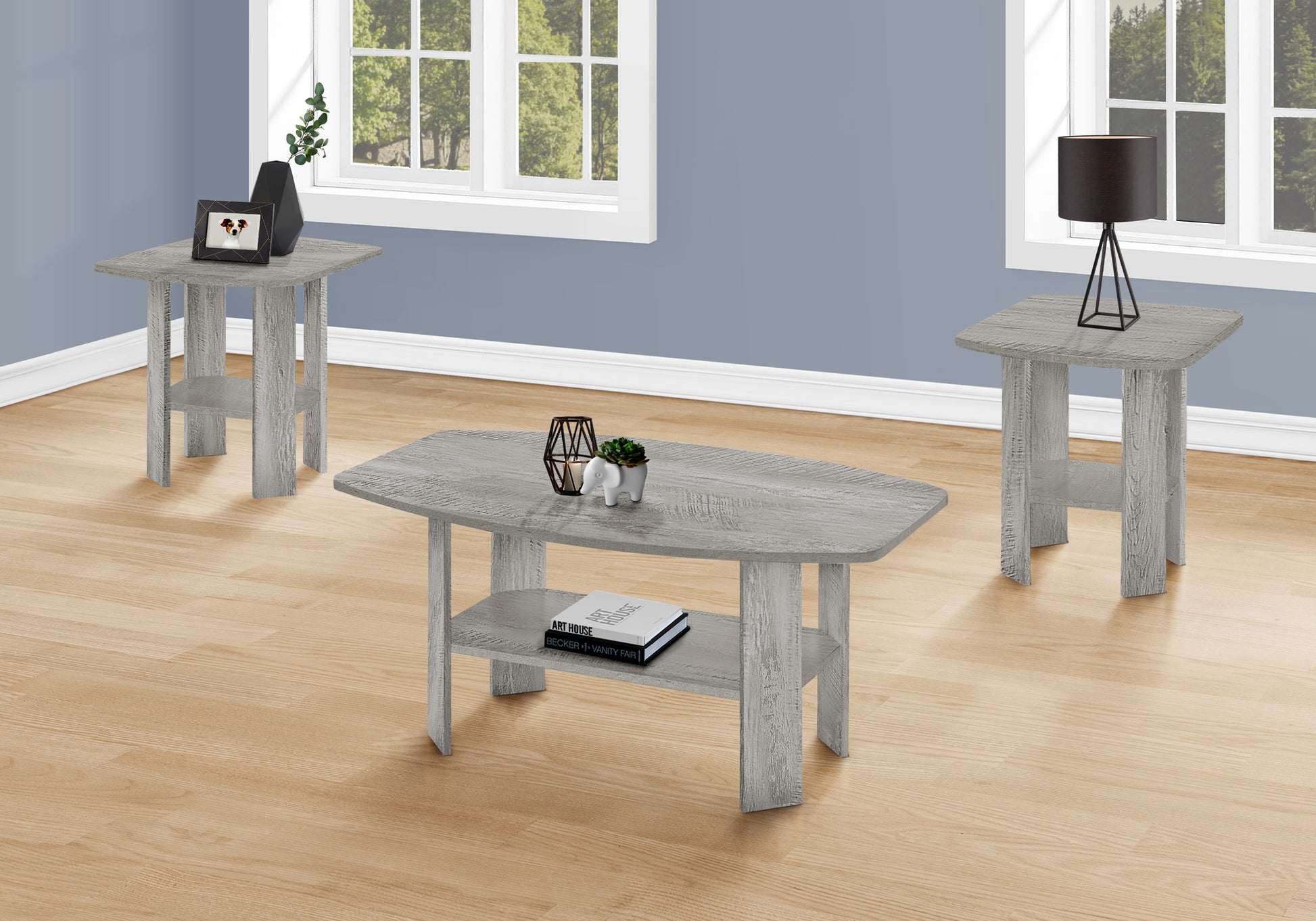 Rustic grey wood coffee table with lower shelf holding books