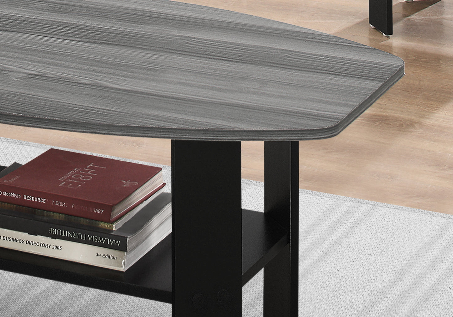 Modern gray wood grain coffee table with black metal legs and a lower shelf