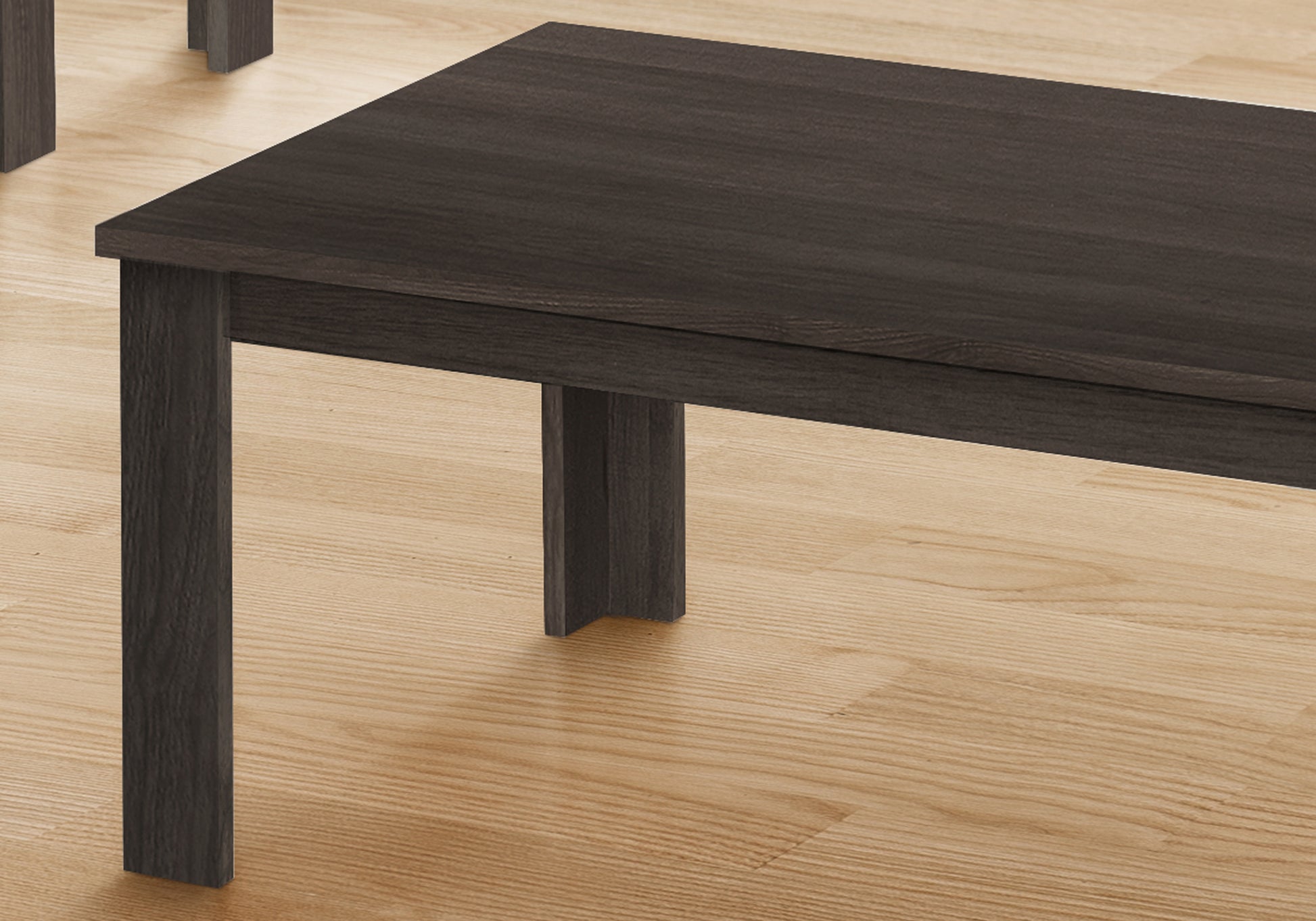 Dark wood dining bench with modern minimalist design on a light wood floor