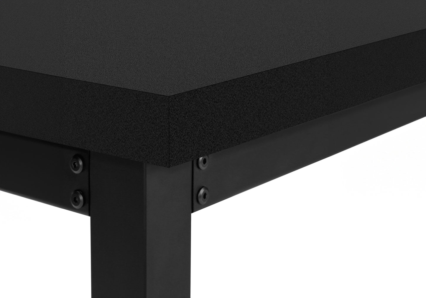 Closeup of a black textured desk surface and metal frame legs