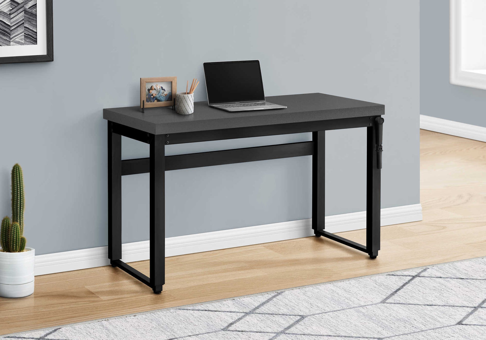Minimalist grey computer desk with black metal frame ideal for home offices