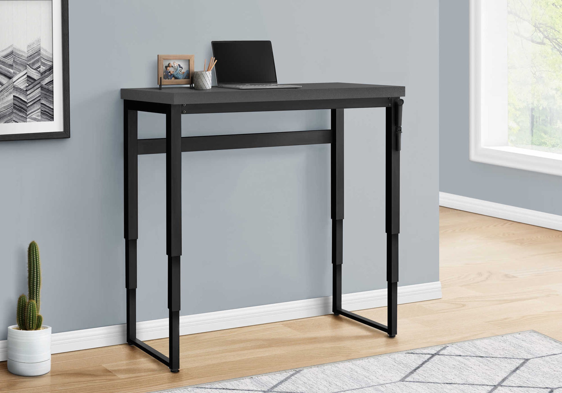 Gray modern standing desk with adjustable black metal legs perfect for home office use