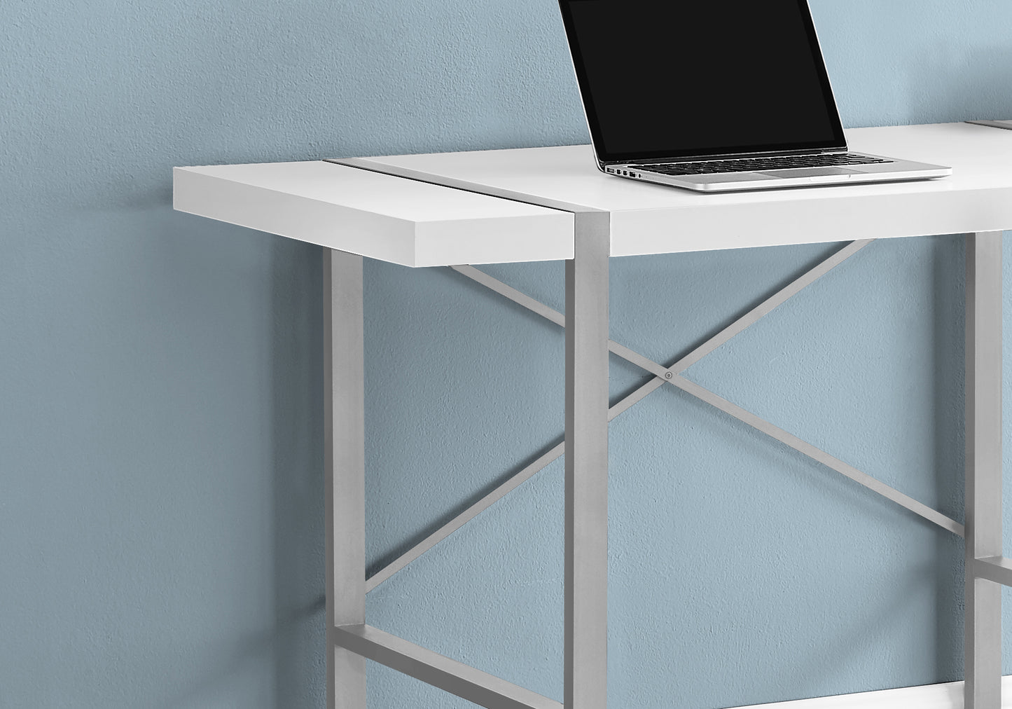 Modern white desk with silver metal frame and laptop ideal for home office