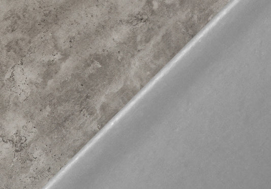 Closeup of textured concrete surface material in gray tones showing its rough finish