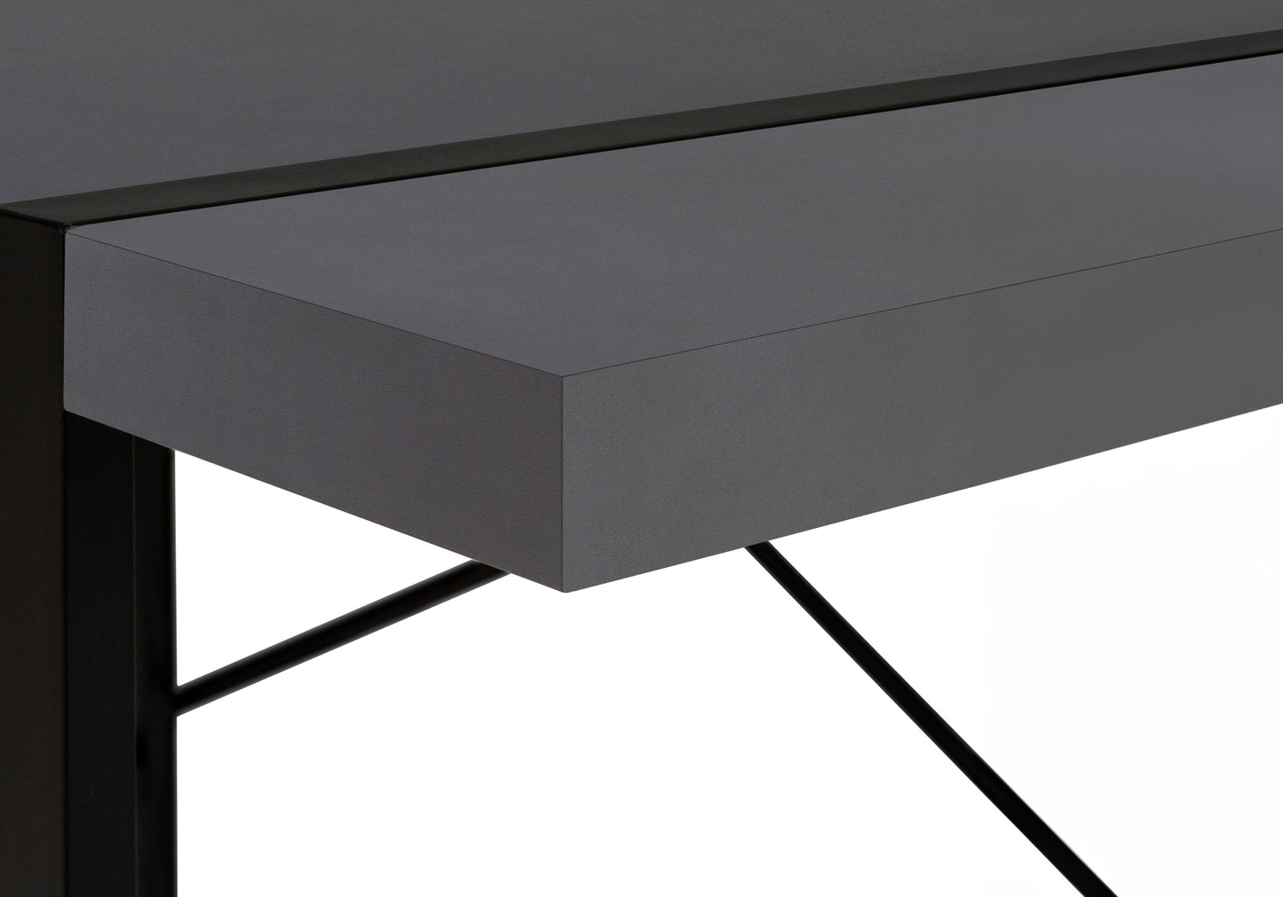Closeup of a modern dark gray desk with sleek black metal legs