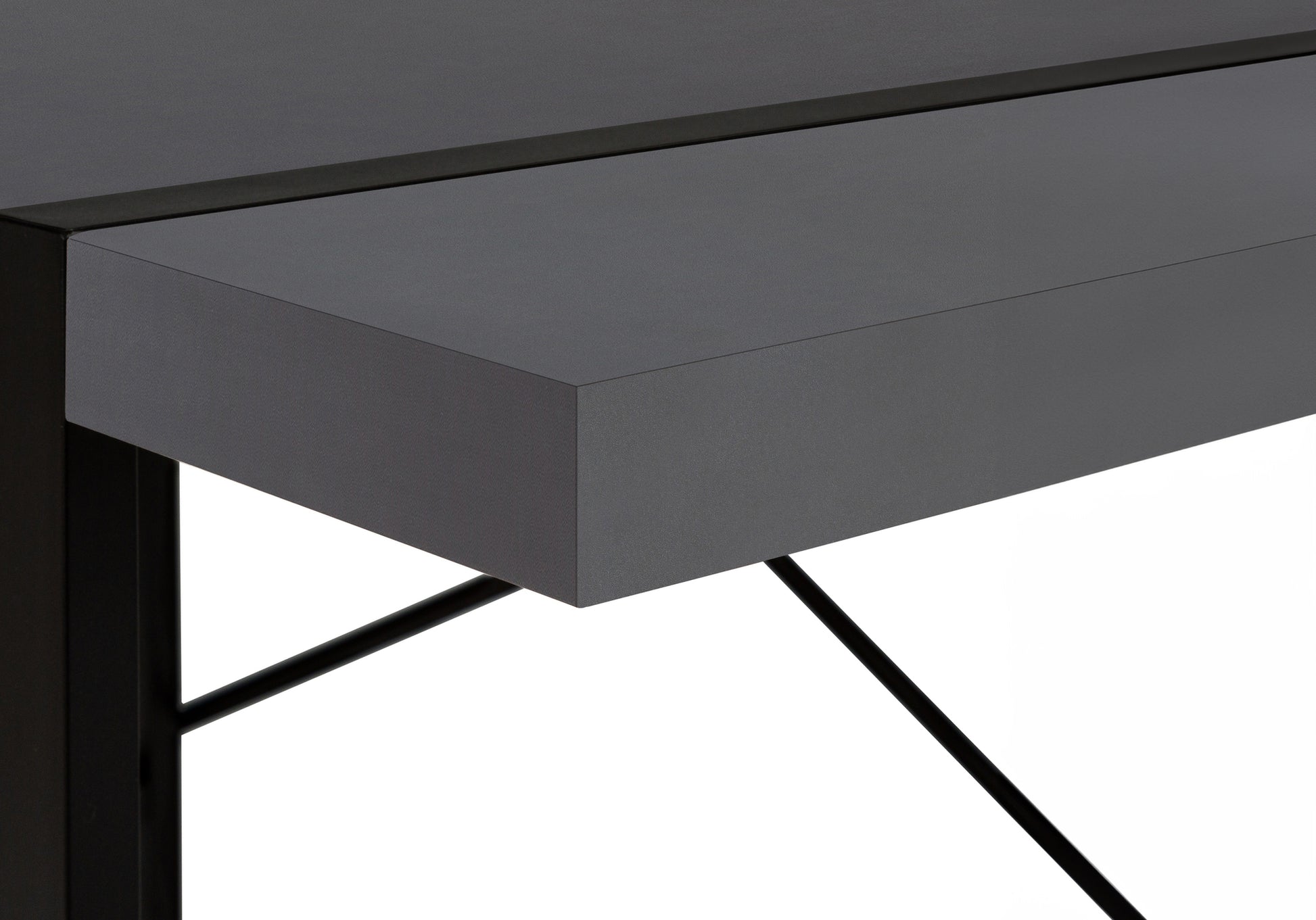 Closeup of a modern dark gray desk with sleek black metal legs