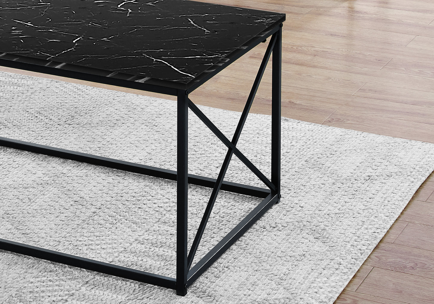 Black marble top coffee table with modern black metal frame on shaggy rug