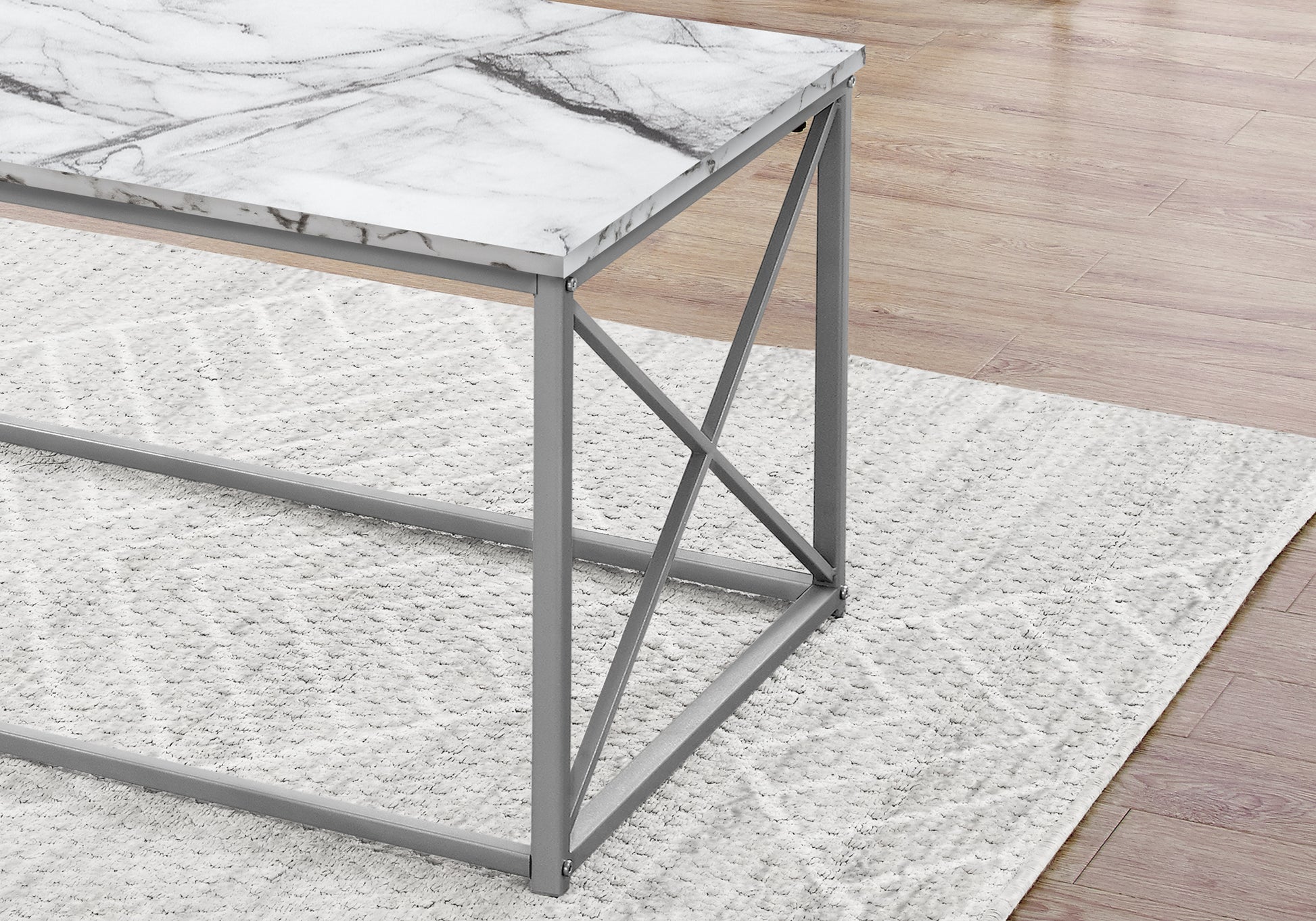 Modern marble top coffee table with gray metal frame and intricate crossleg design