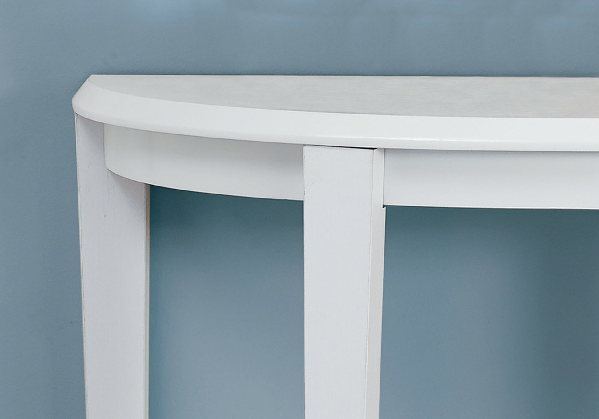 Curved white entryway table with minimalist design perfect for small spaces