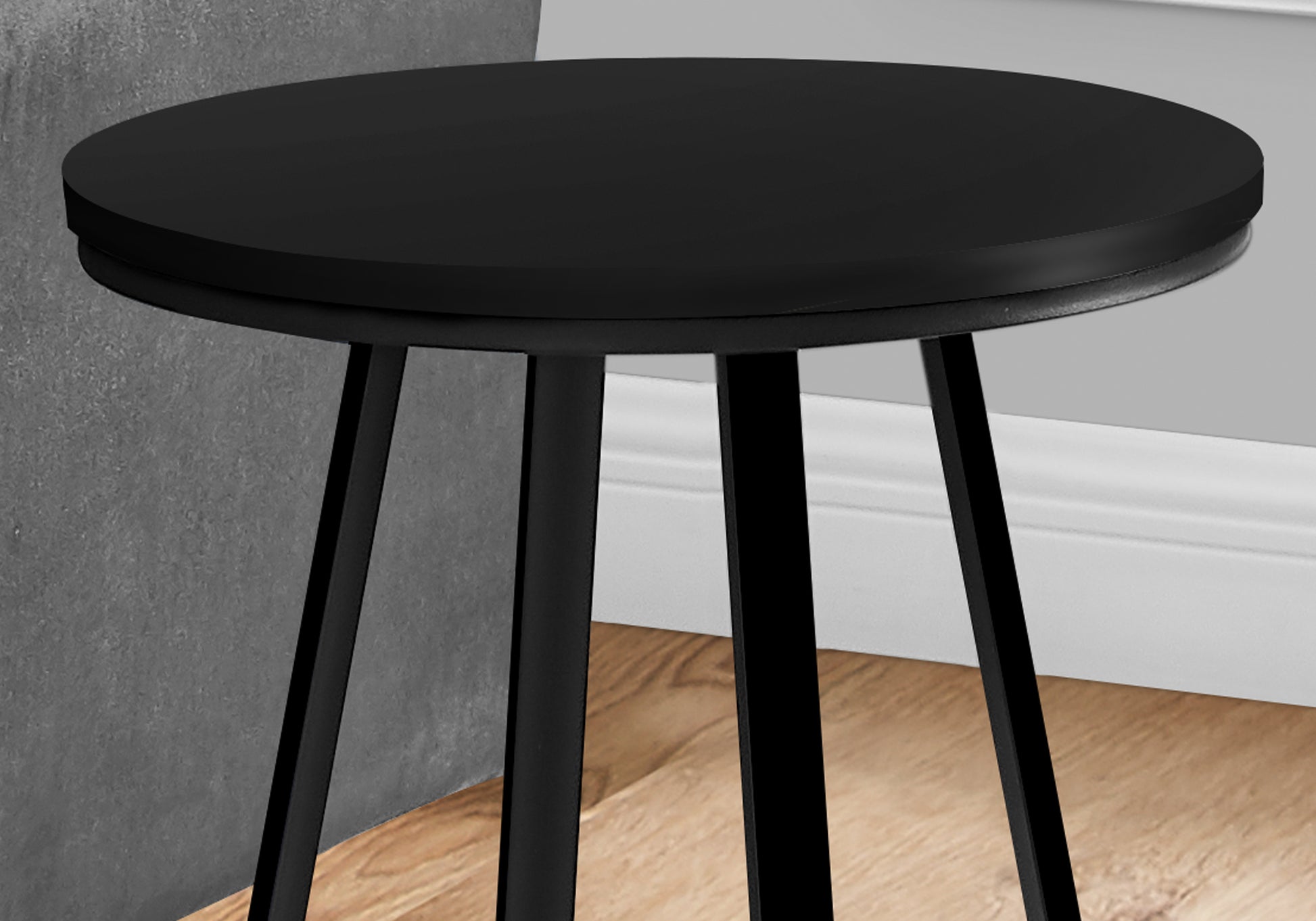 Black round end table with sleek metal legs perfect for living room decor