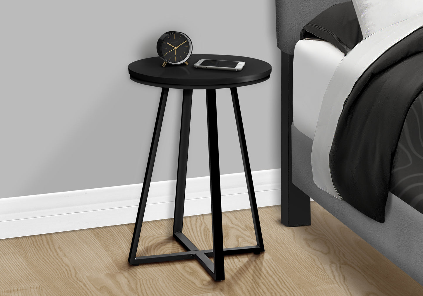 Minimalist black round end table with metal legs perfect for bedside use