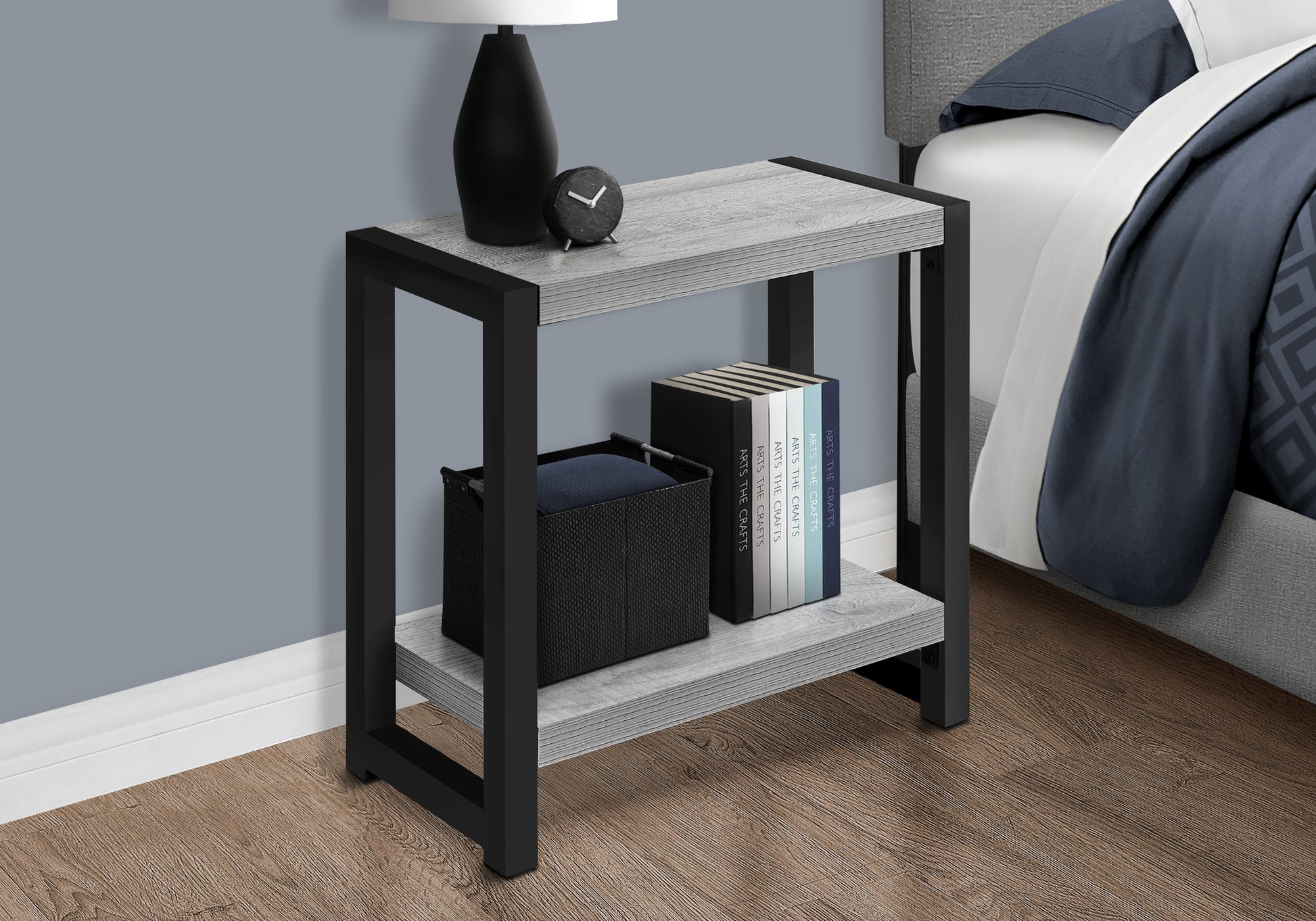 Rustic grey wood and black metal shelf nightstand with a black basket and books